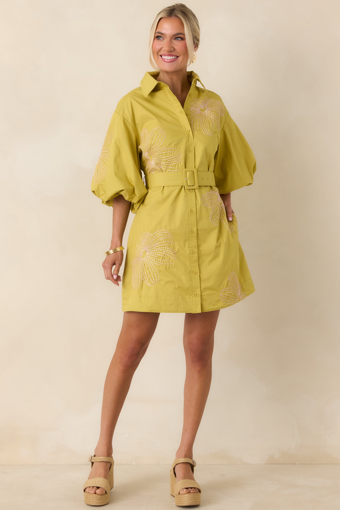 Cotton mini dress with collared neckline, button-front design, puff sleeves, and light pink embroidery.