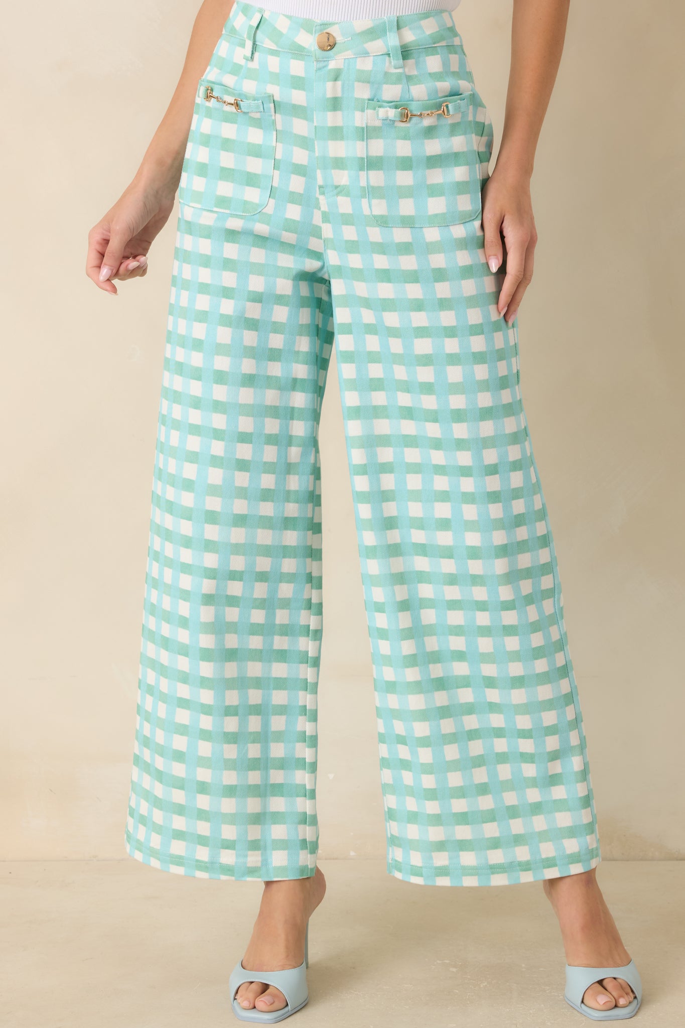 High-rise gingham pants showcasing gold horsebit-inspired hardware accents and functional front patch pockets.