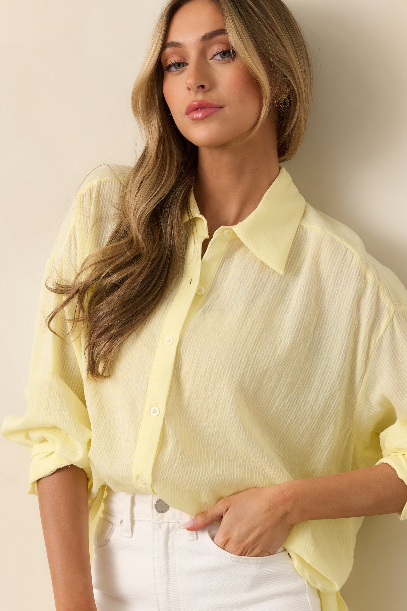 A close-up of the blouse’s collared neckline and upper buttons, highlighting the structured design.