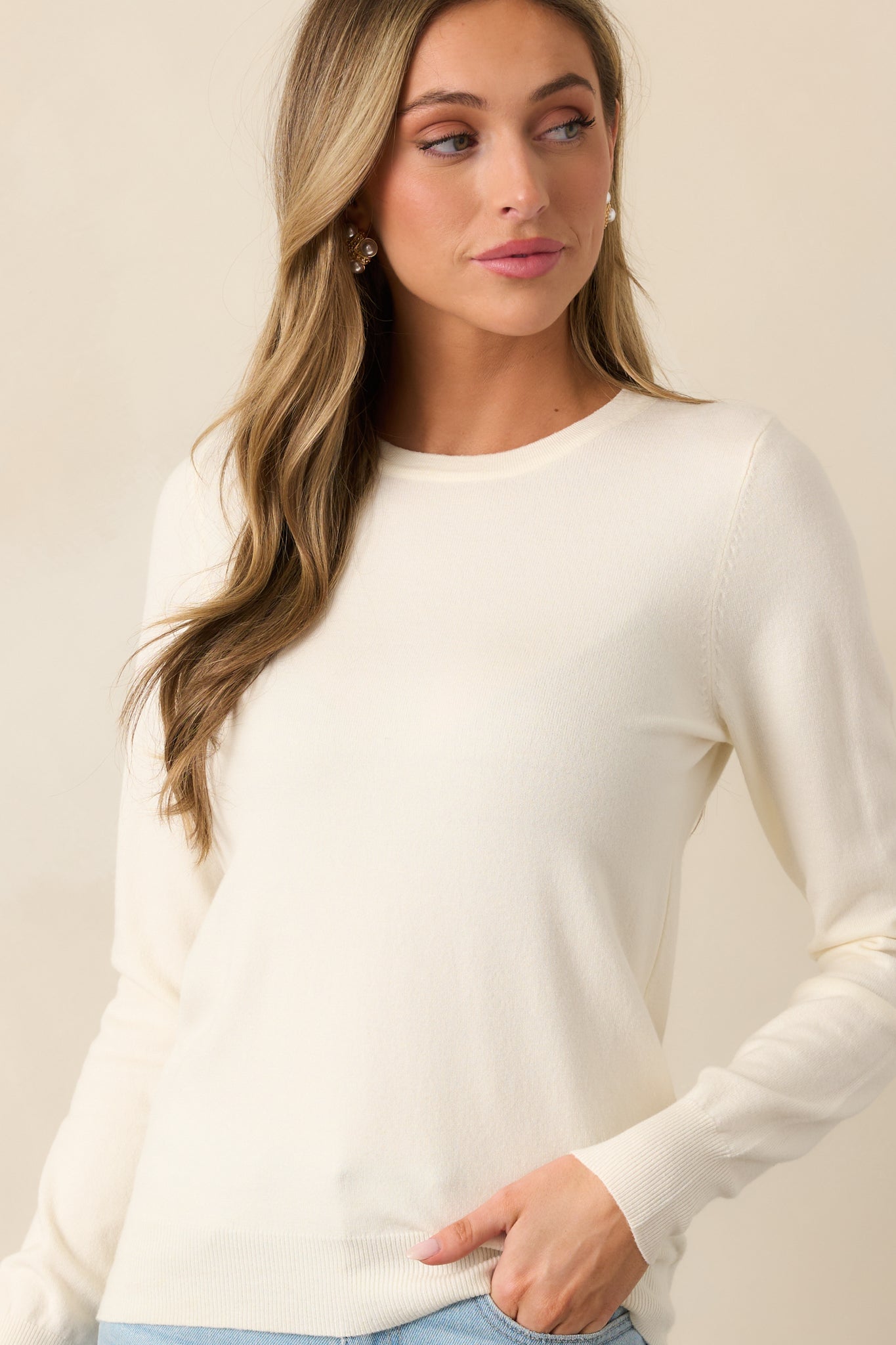 The relaxed fit and rib knit hems of this ivory sweater add to its effortlessly comfortable style.