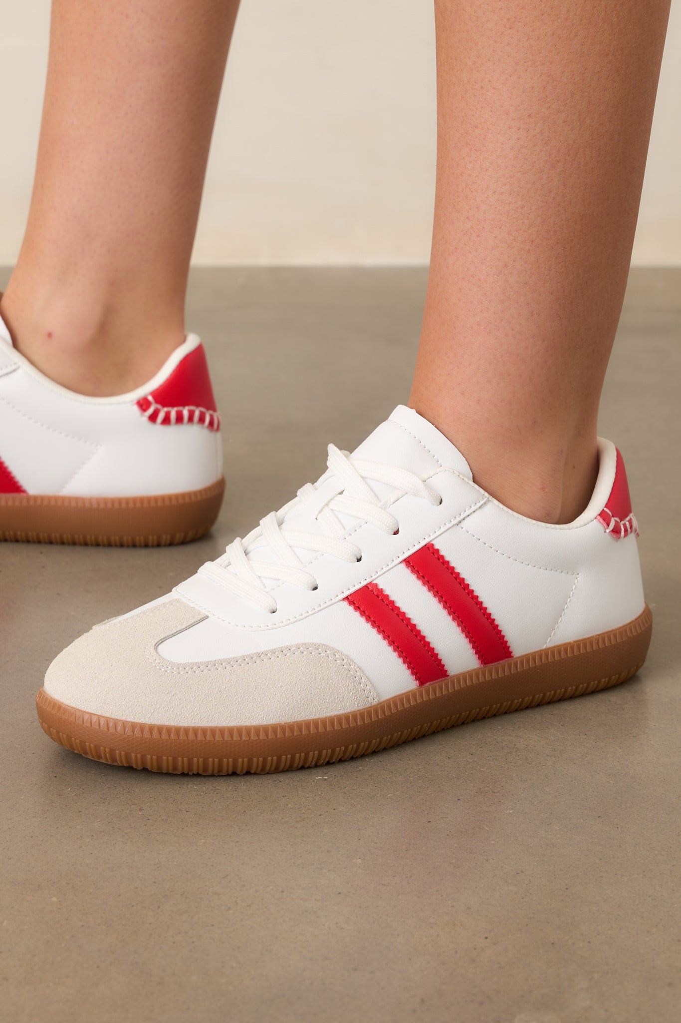 A detailed view of the brown sole and how it complements the white and red elements of the sneaker.