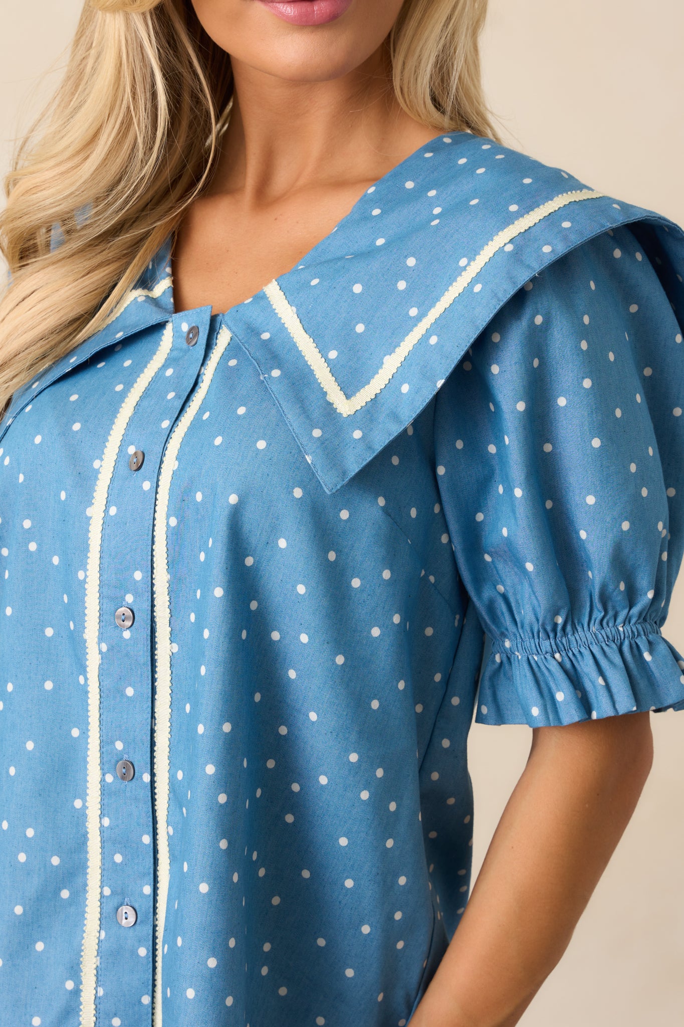 Zoomed-in image of the top’s ivory trim and polka dot pattern, highlighting fine details in the fabric and stitching.