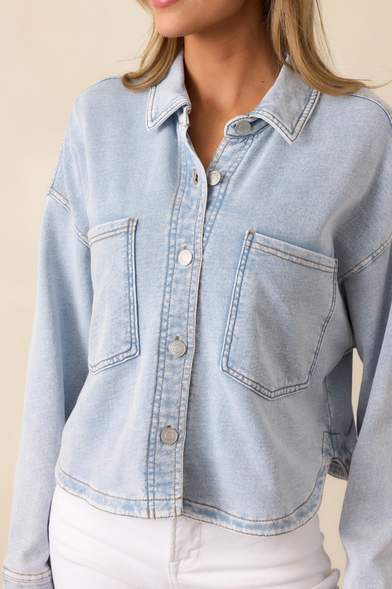 A zoomed-in shot showcasing the detailed stitching and textured fabric, enhancing the vintage-inspired feel of this washed indigo jacket.