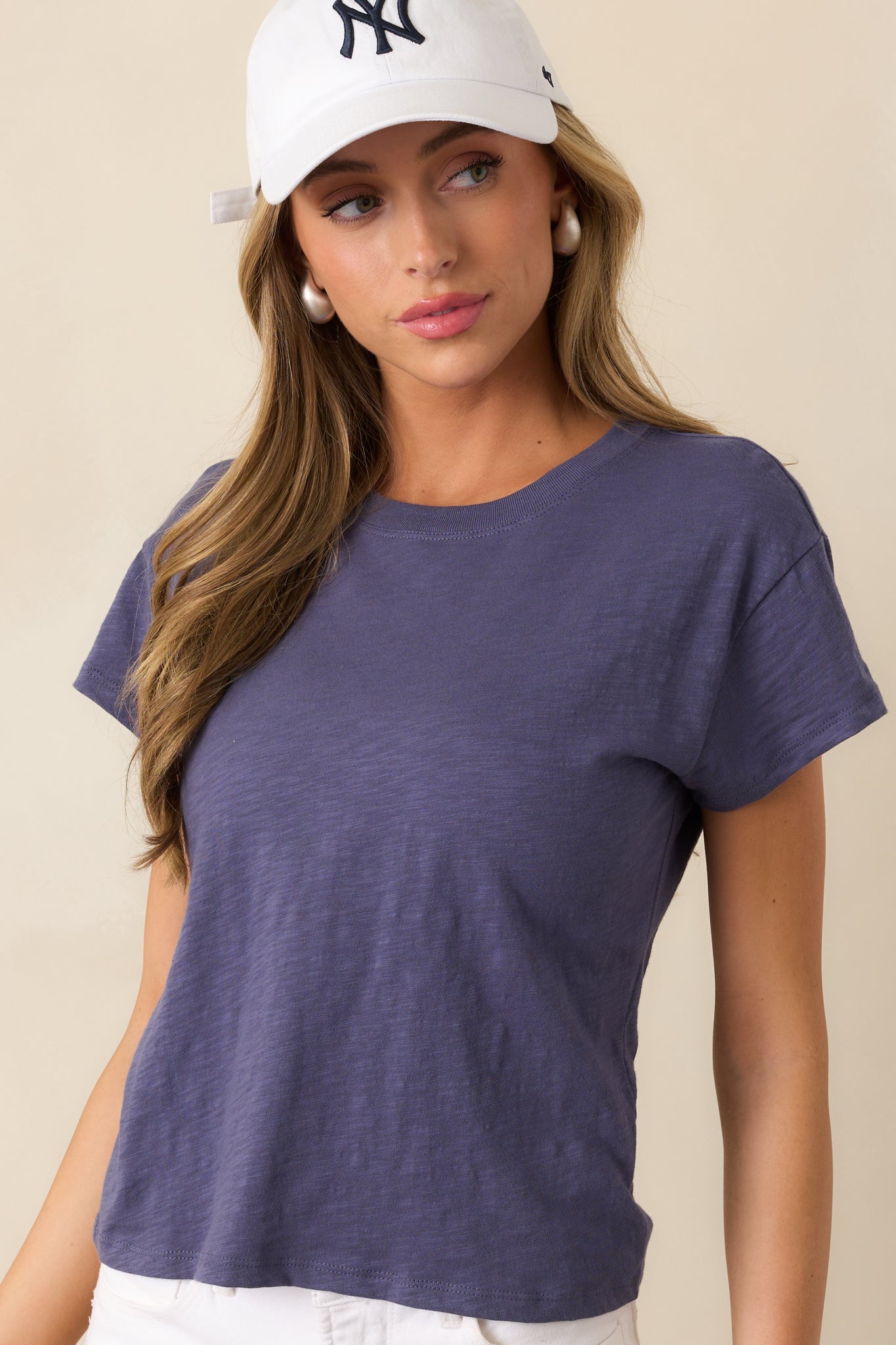 A closer look at the crew neckline and soft fabric of this effortlessly cool worn blue tee.