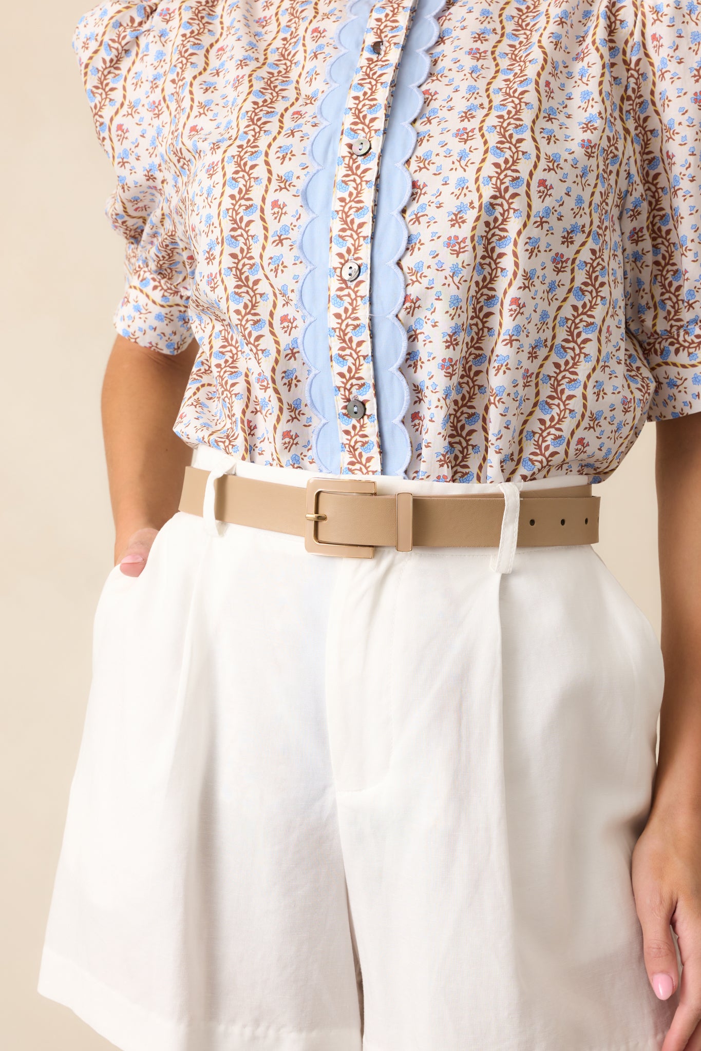 A front view of the tan belt, highlighting its thick smooth material.