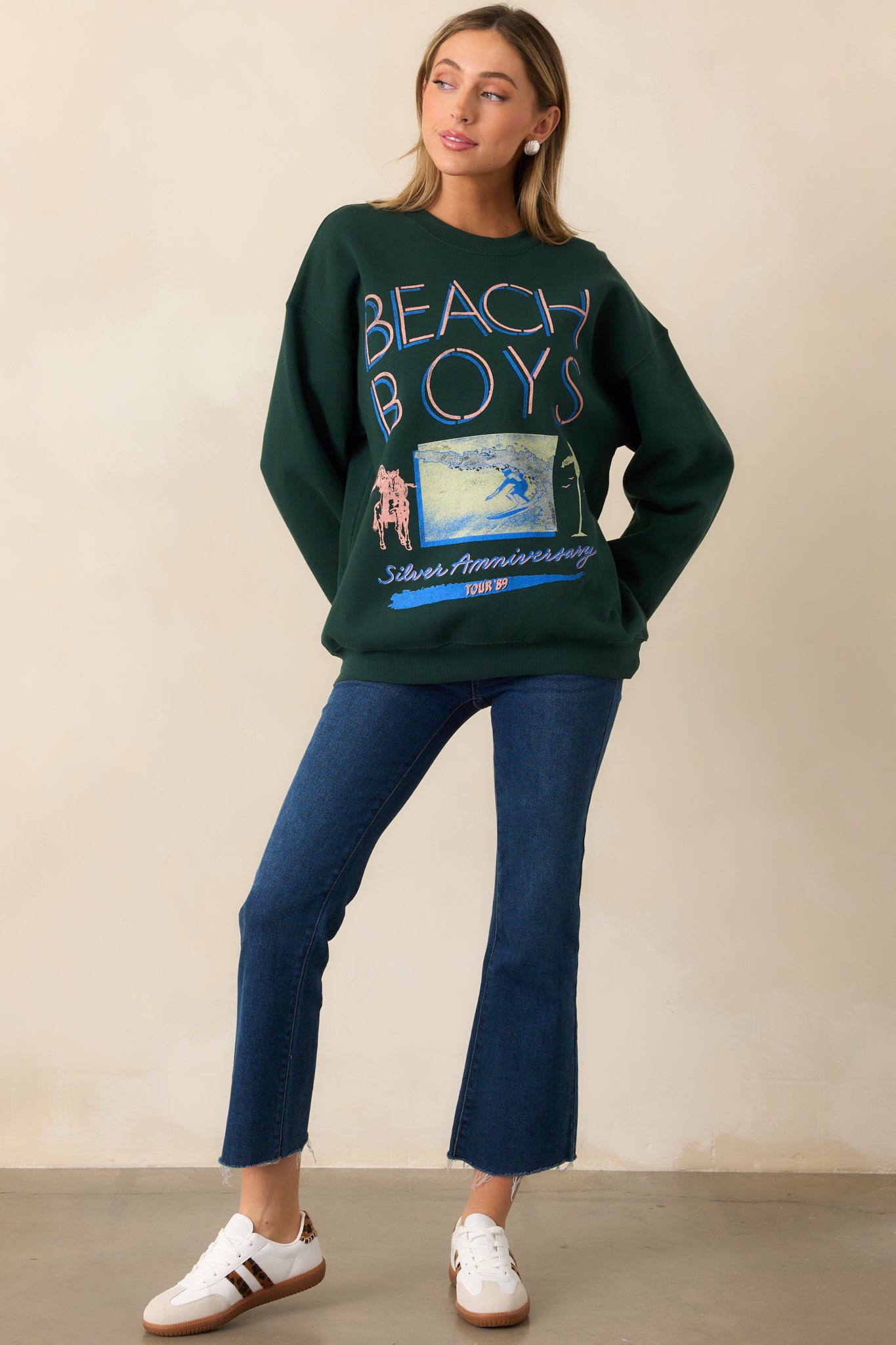A pine green sweatshirt with a crew neckline, long sleeves, and a vintage-inspired surf graphic.