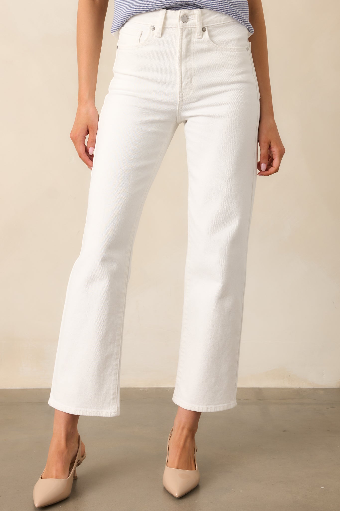 The secure button and zipper closure, along with functional belt loops, provide a polished and versatile design.