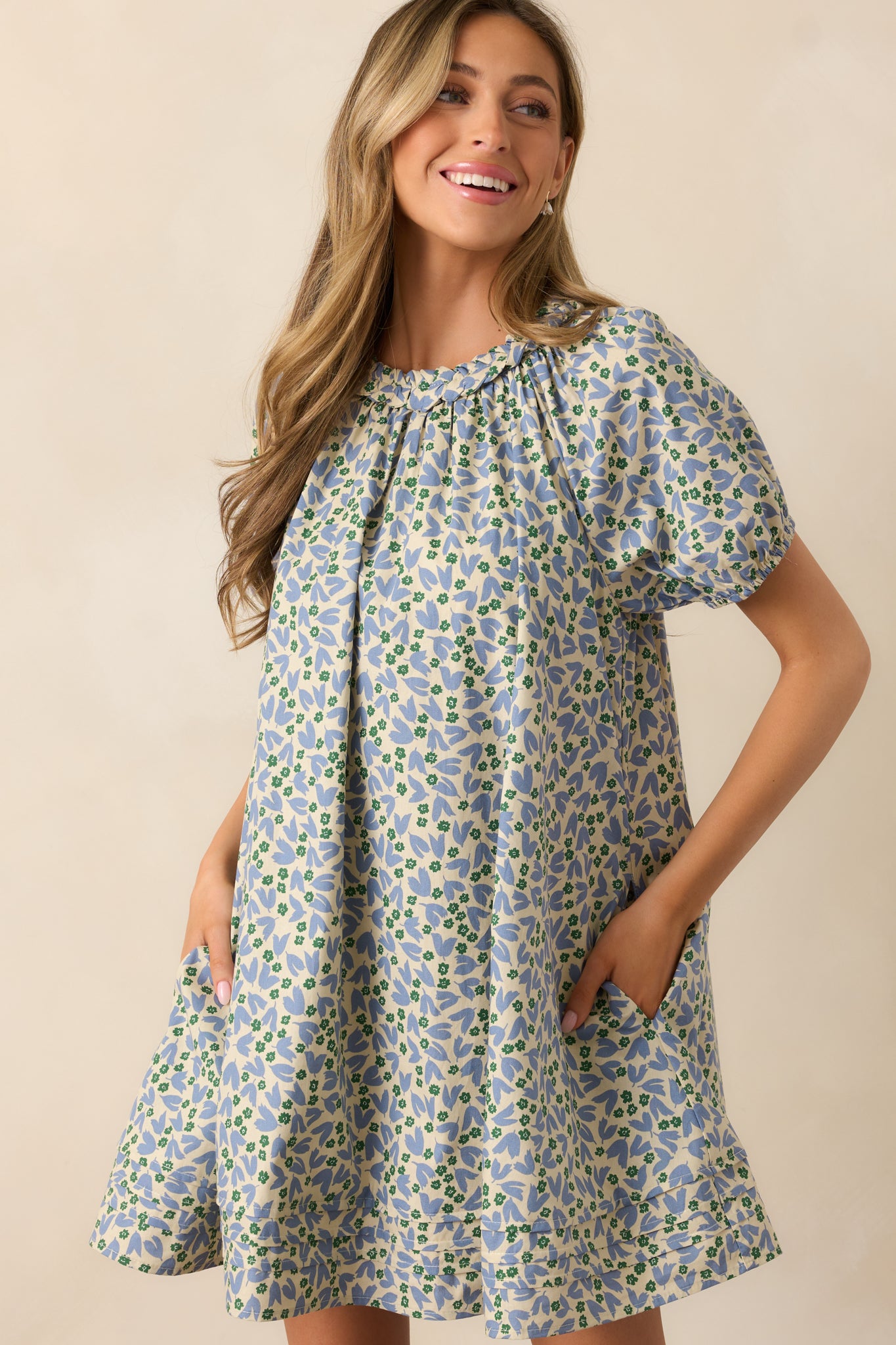 Side angle of the dress, capturing the airy tiered hem and relaxed sleeve fit.