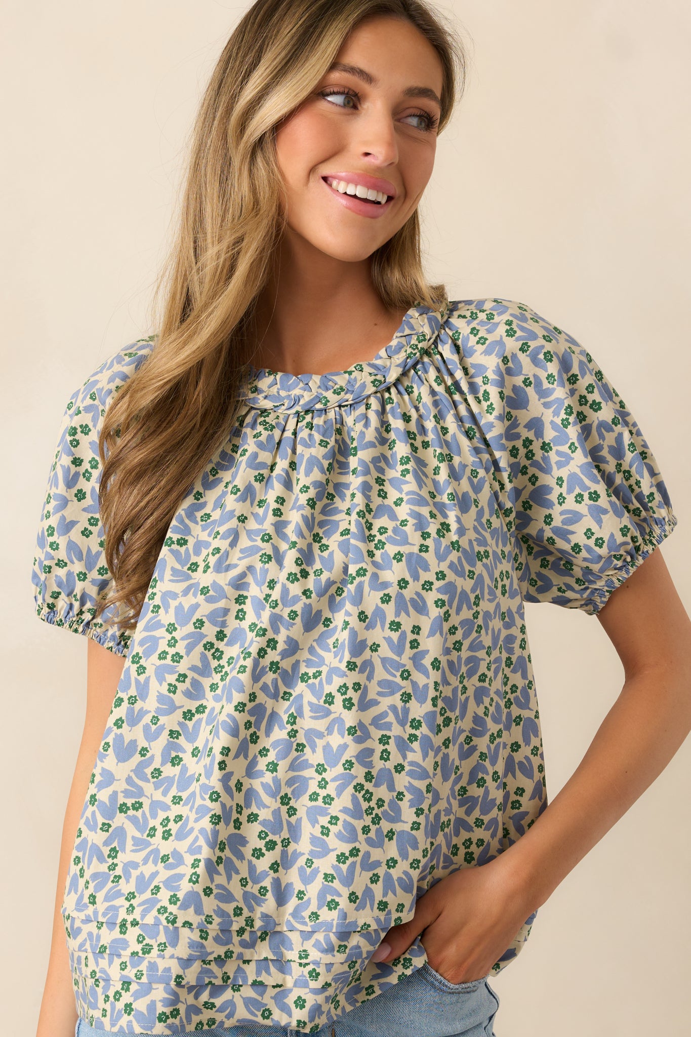 Closer look at the blouse, focusing on the intricate braided round collar.