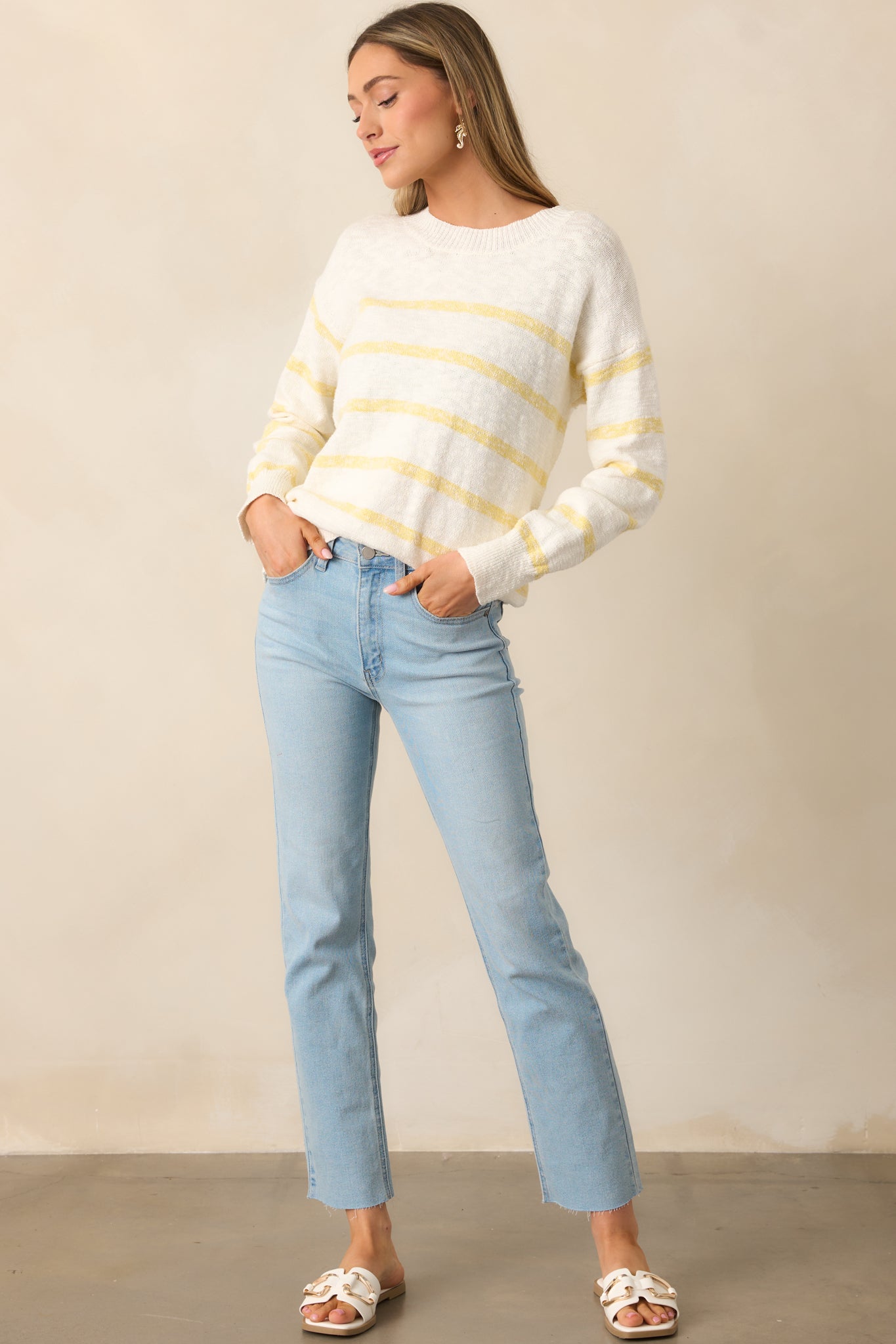 Ivory sweater with a lightweight design and yellow stripe detailing, perfect for a casual yet polished look.