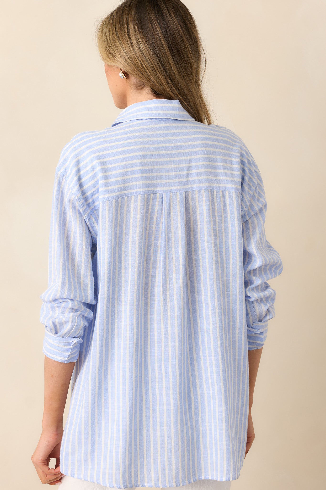 The back of the light blue stripe top, displaying the structured fit and continuation of the stripe pattern.