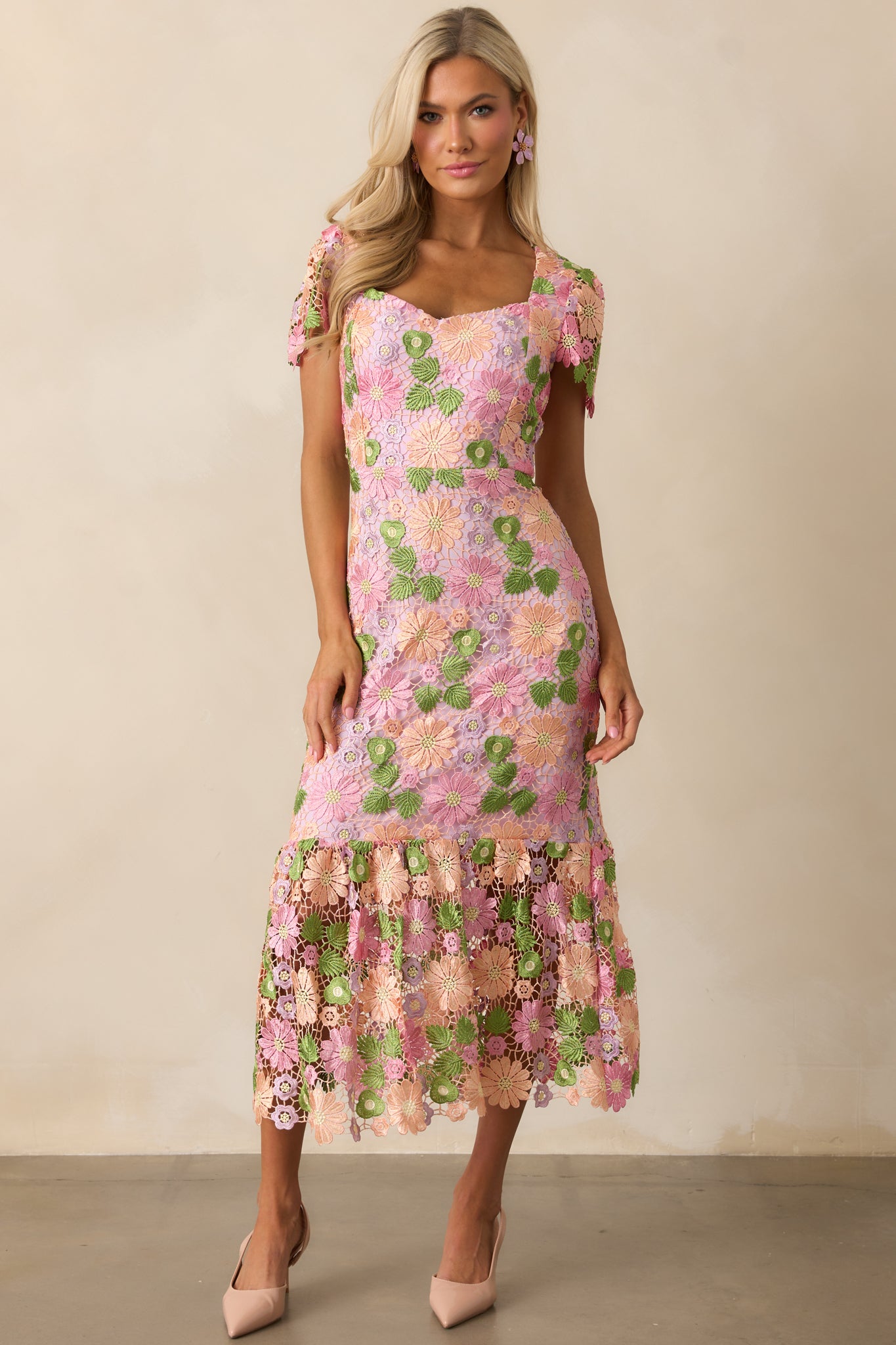 Floral embroidery covers the dress, with a relaxed embroidered detail adding texture and charm.