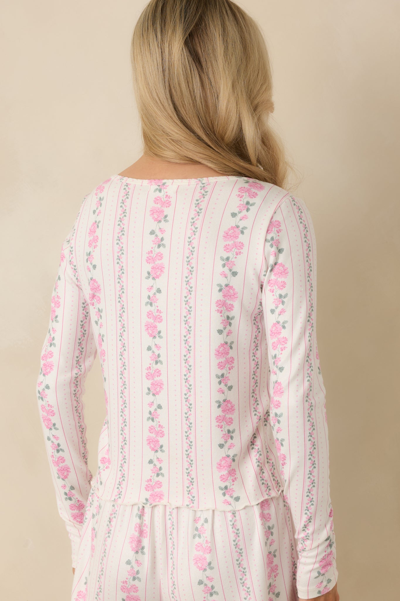 Ivory long sleeve knit top shown from the rear, highlighting the textured fabric and continuous floral stripe detailing.