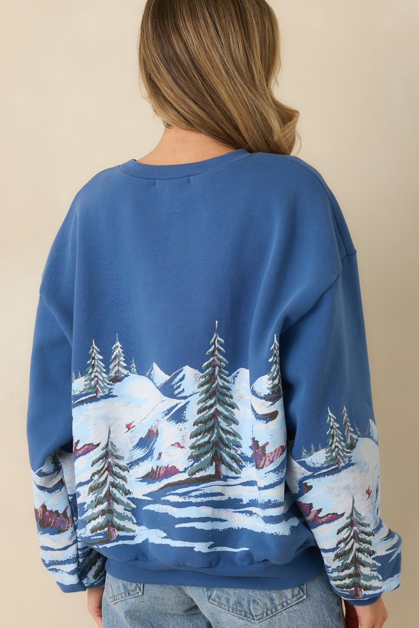 Rear view of the dark blue crewneck sweatshirt displaying a clean, solid finish with ribbed hem and cuffs.