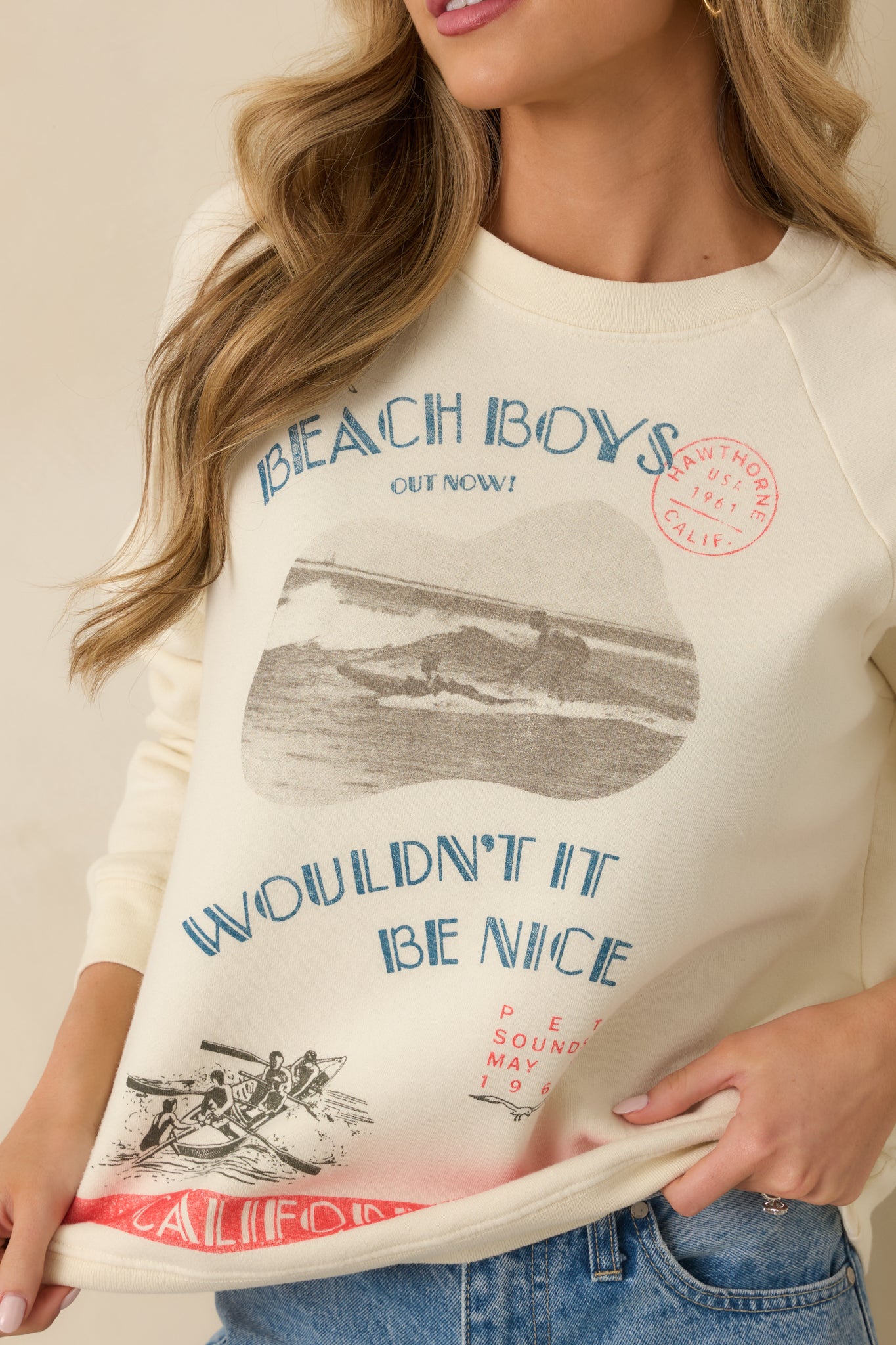 Detailed look at the “Wouldn’t It Be Nice” text and playful beach-themed graphics on soft ivory fabric.
