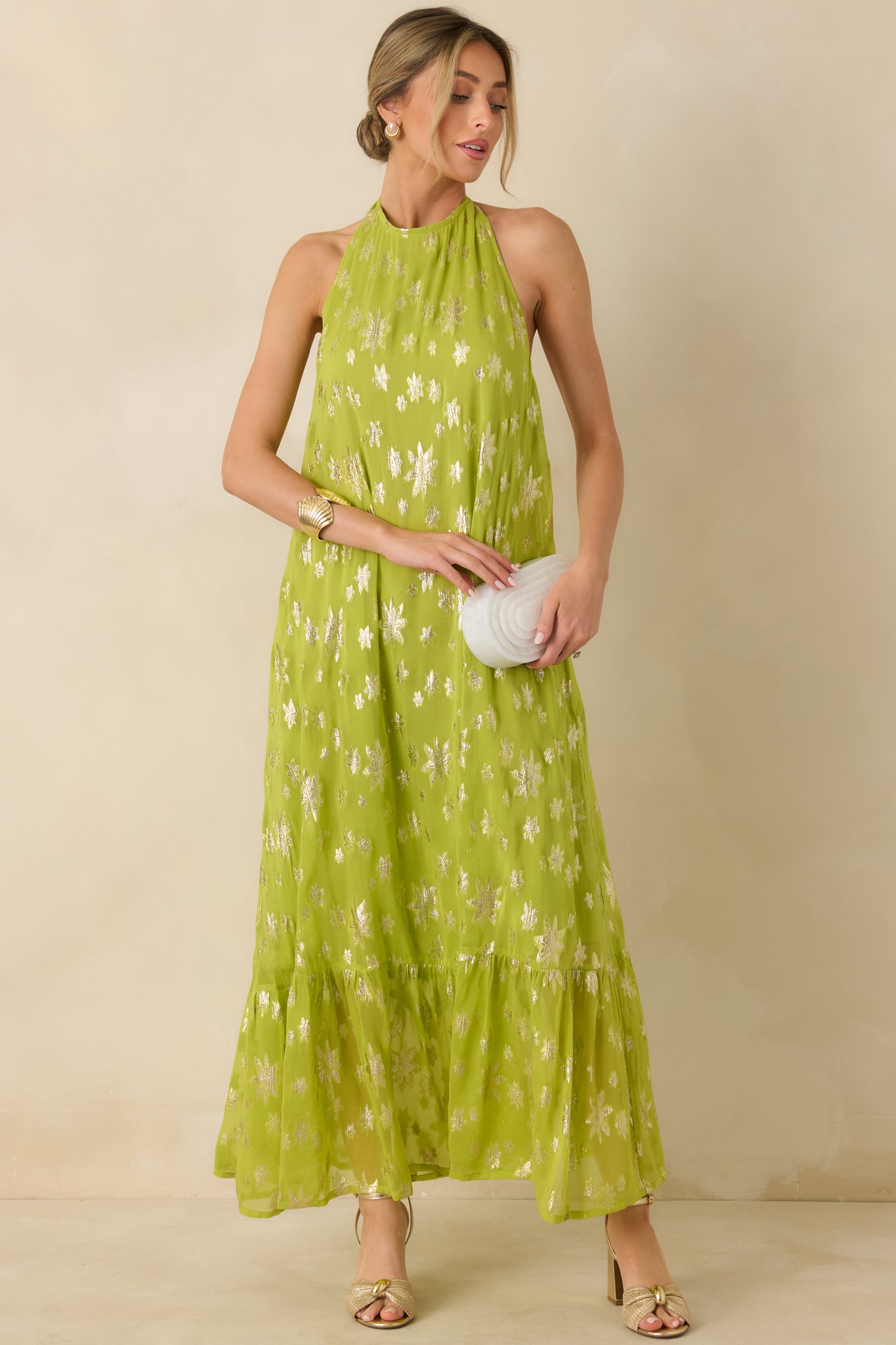 Fully lined chartreuse maxi dress featuring a halter neckline and shimmering floral accents throughout.
