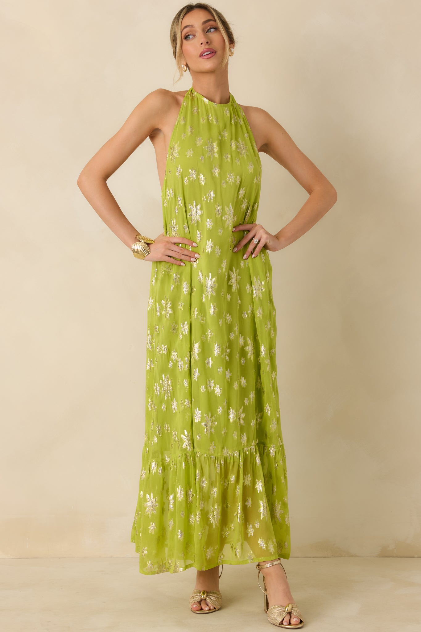 Halter-style chartreuse maxi dress with allover metallic floral detail and graceful tiered movement.