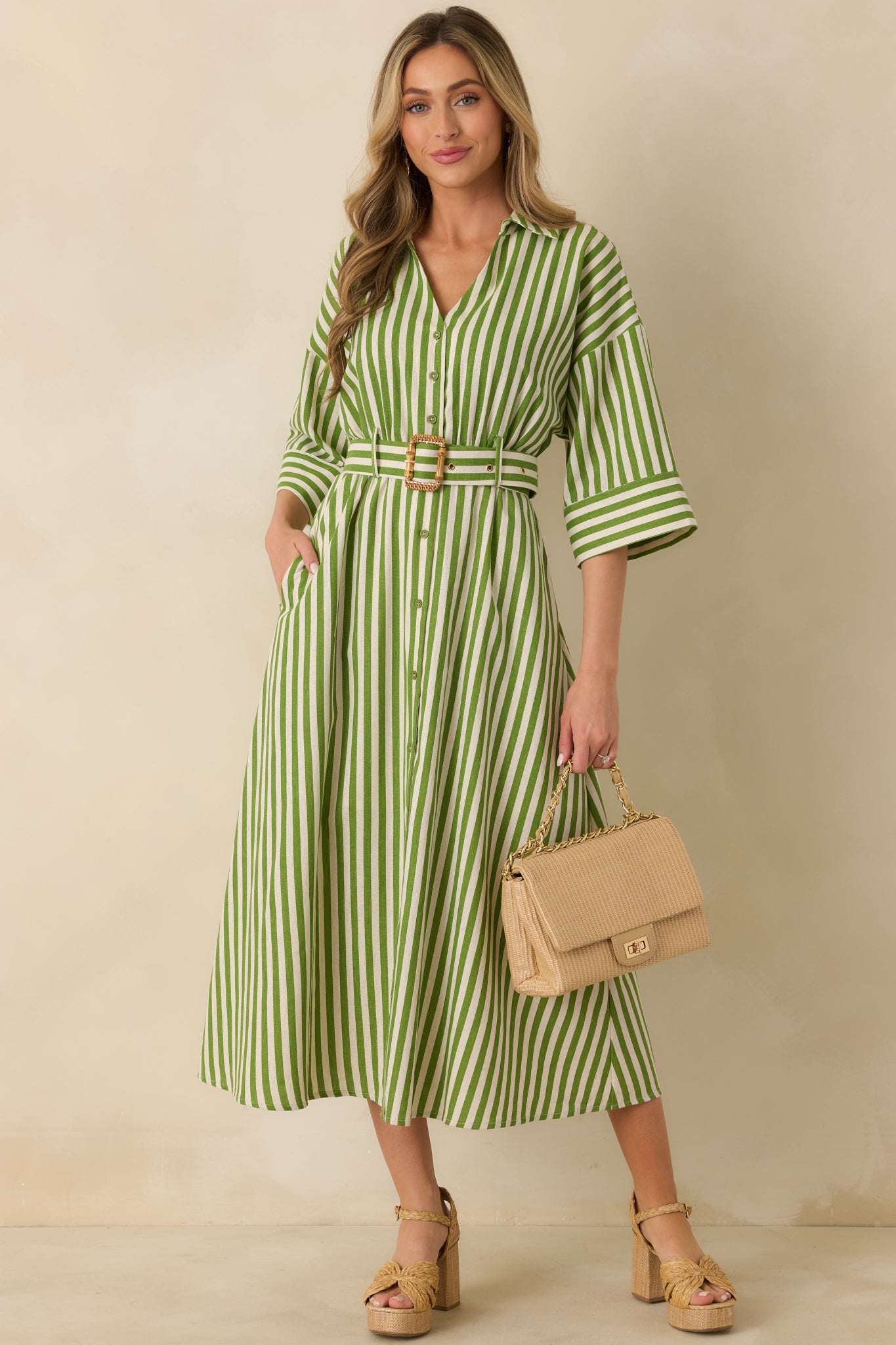 Green striped maxi shirt dress with lightweight woven fabric, classic collar, and flowing button-front design
