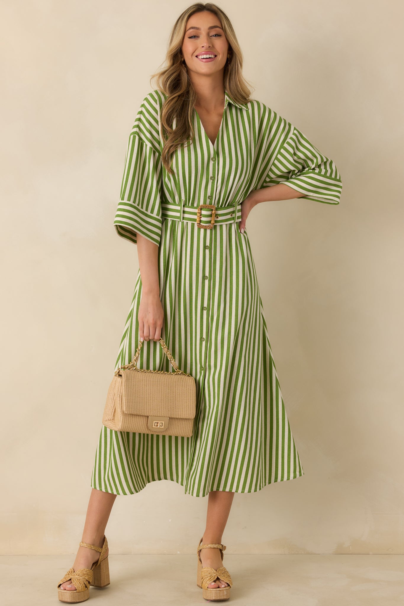 Lightweight green striped maxi dress featuring elbow-length sleeves, vertical striping, and easy full-length movement