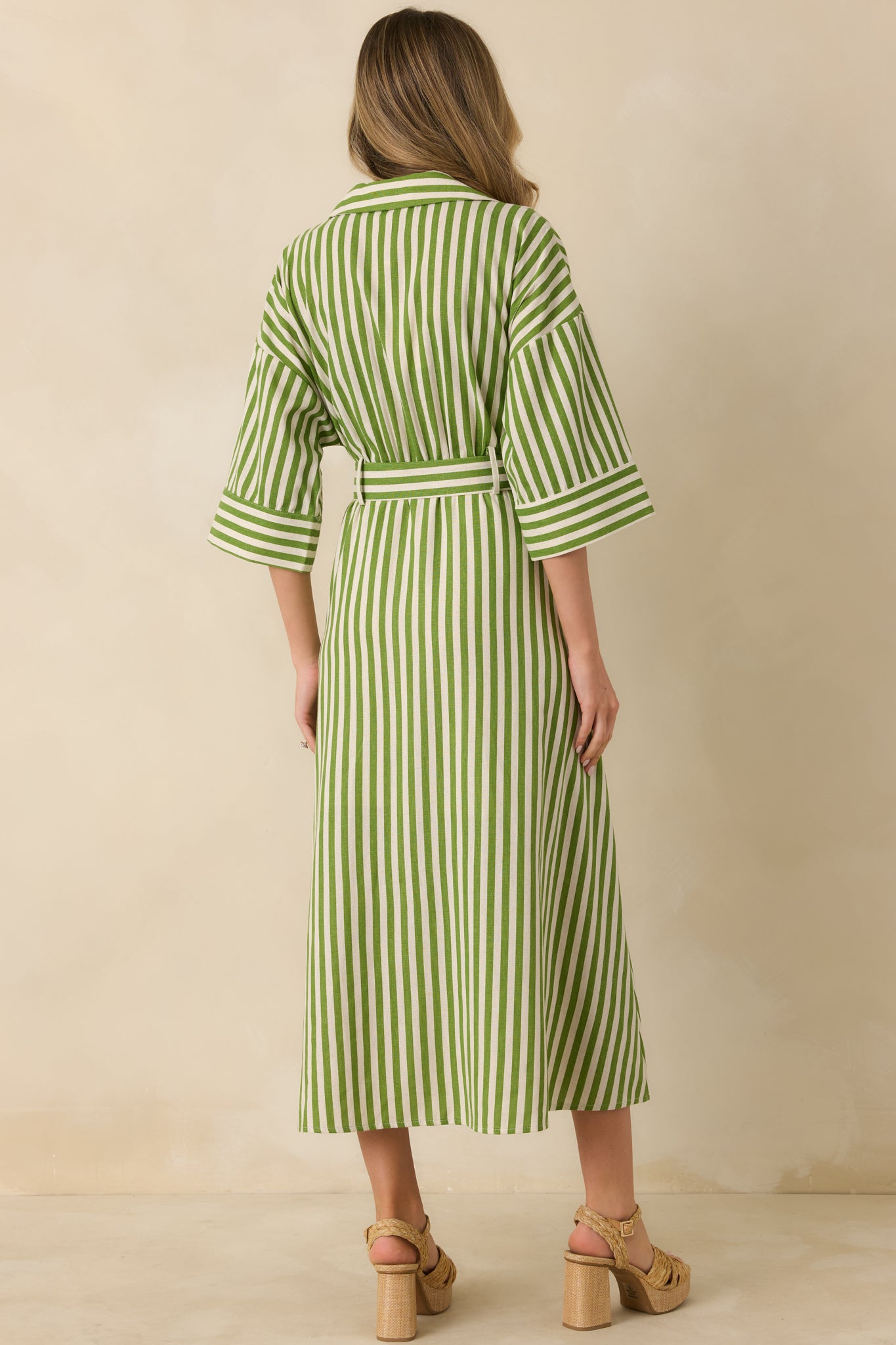 Green striped maxi shirt dress showing a smooth rear view with flowing length and removable matching belt for shaping