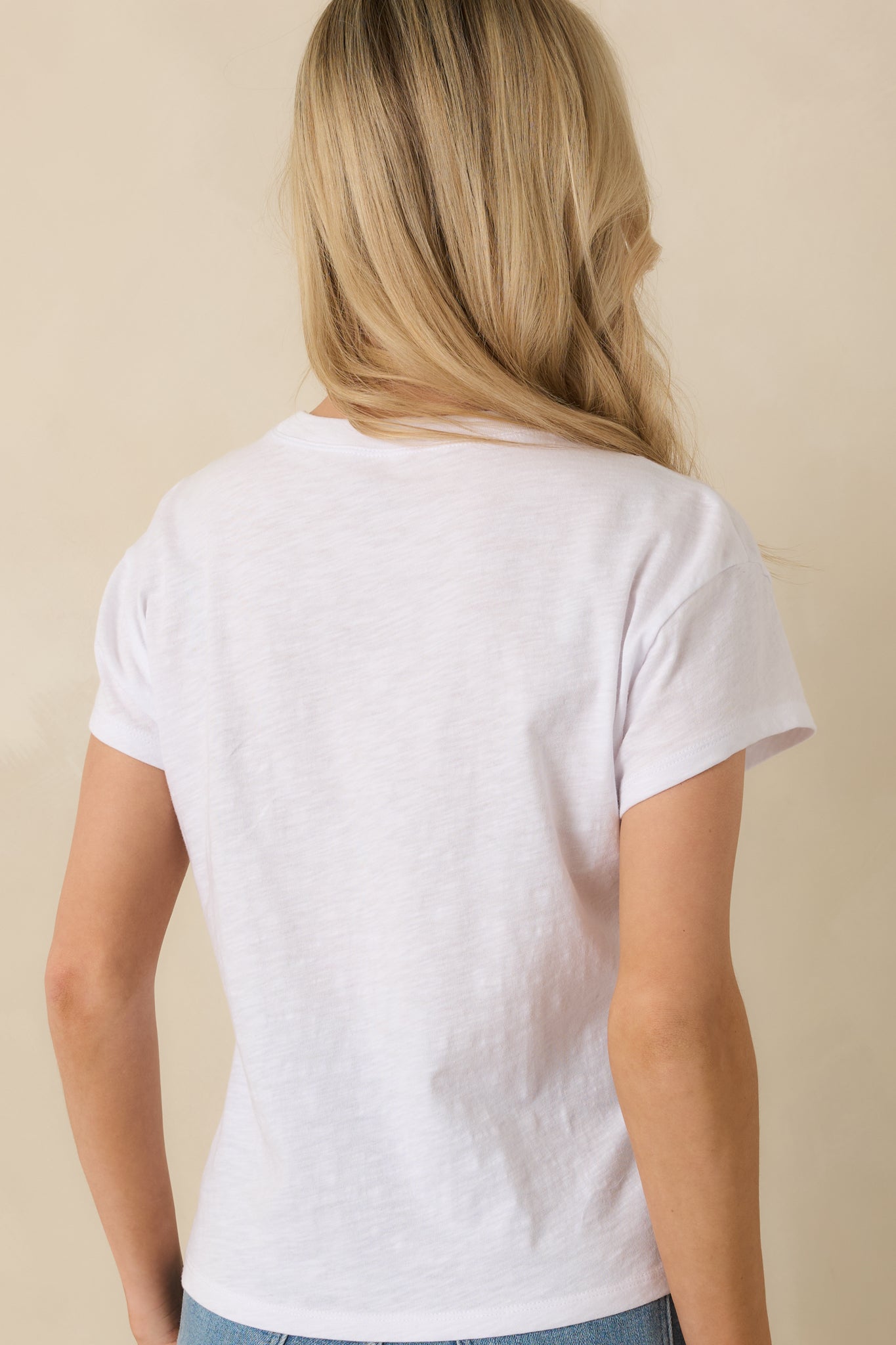 Rear view of white cotton tee highlighting regular fit and short sleeve design.