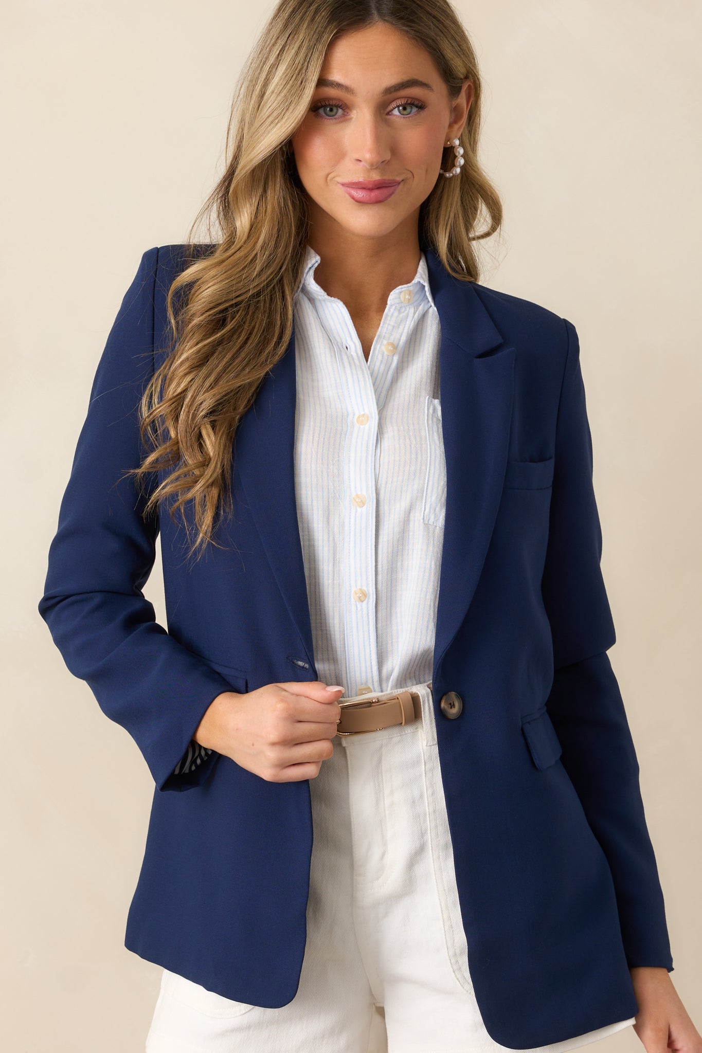 A close-up of the navy blazer’s structured lapel neckline and smooth fabric texture.