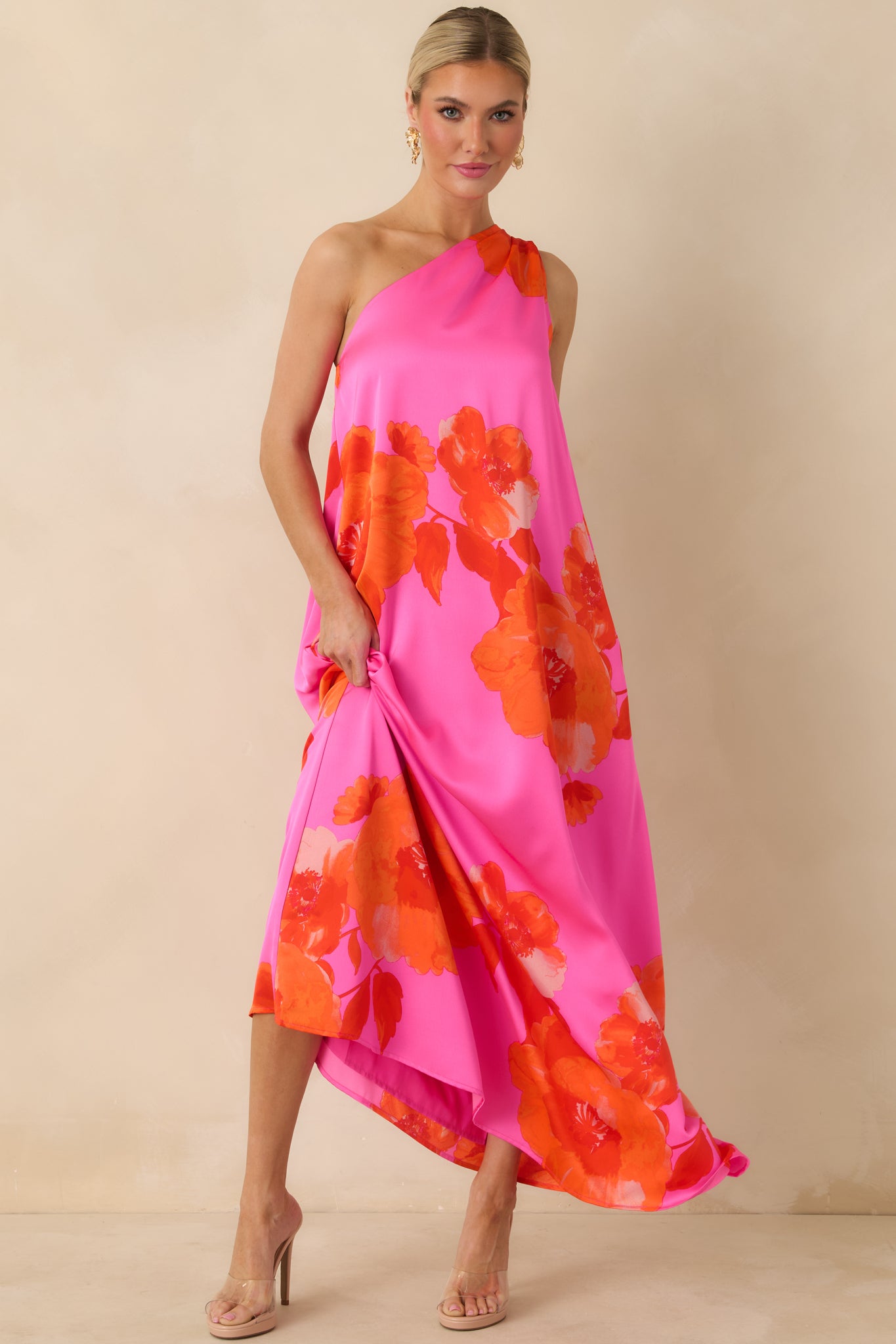 Pink maxi dress highlighting the floral pattern, flowing fabric, and practical pocket details.