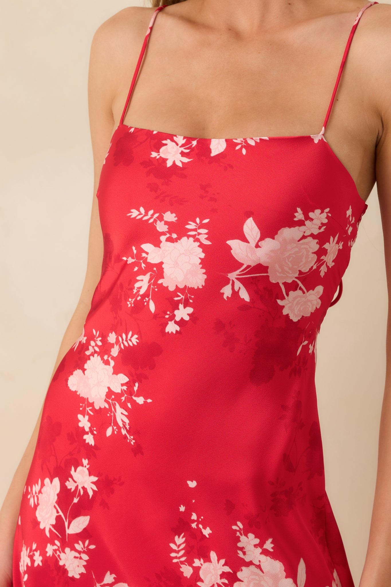 Close-up of the red floral woven fabric and bodice detailing, showing the smooth texture and refined finish.