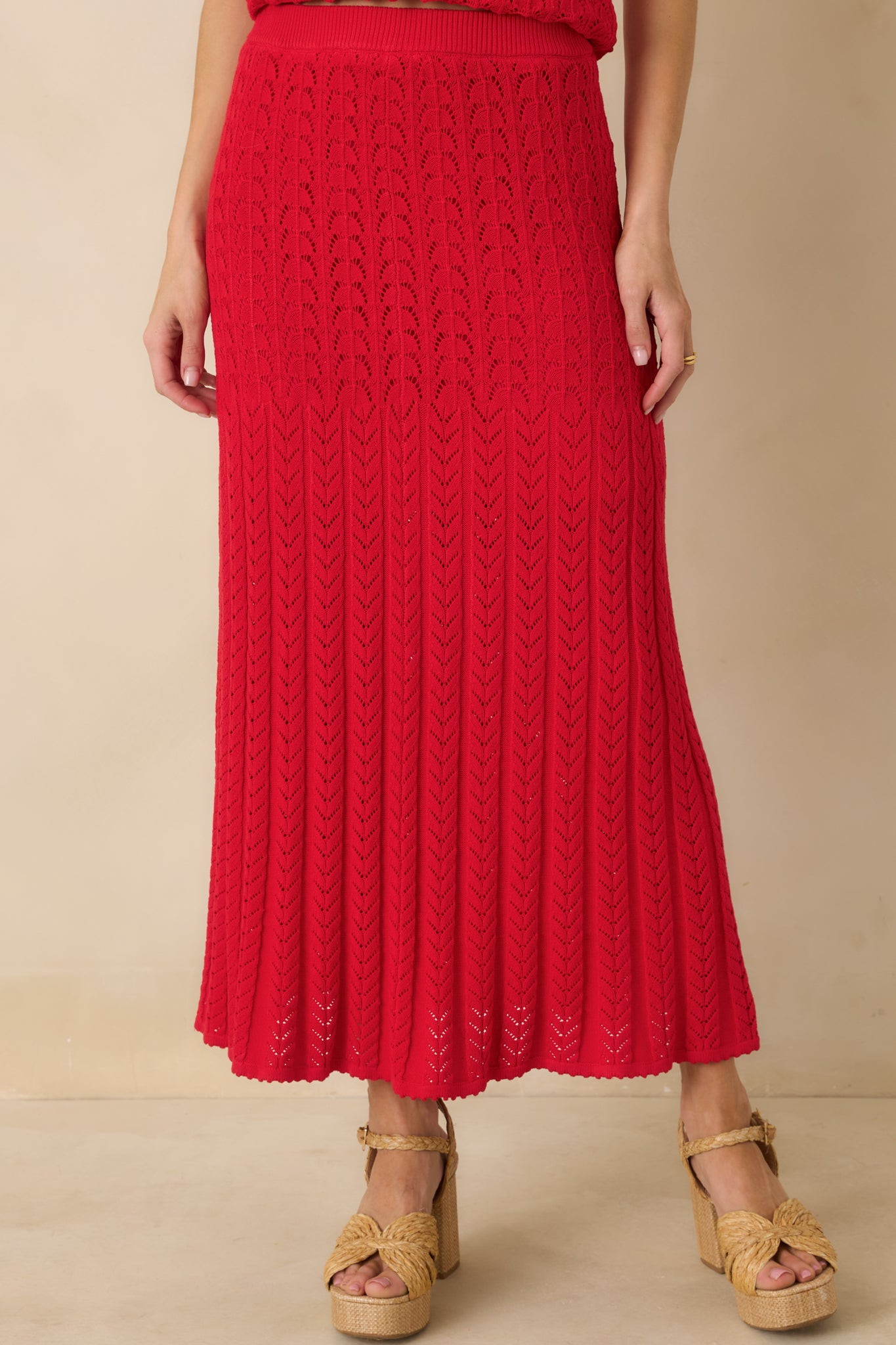 Red knit skirt fabric shown with subtle texture and flexible stretch.