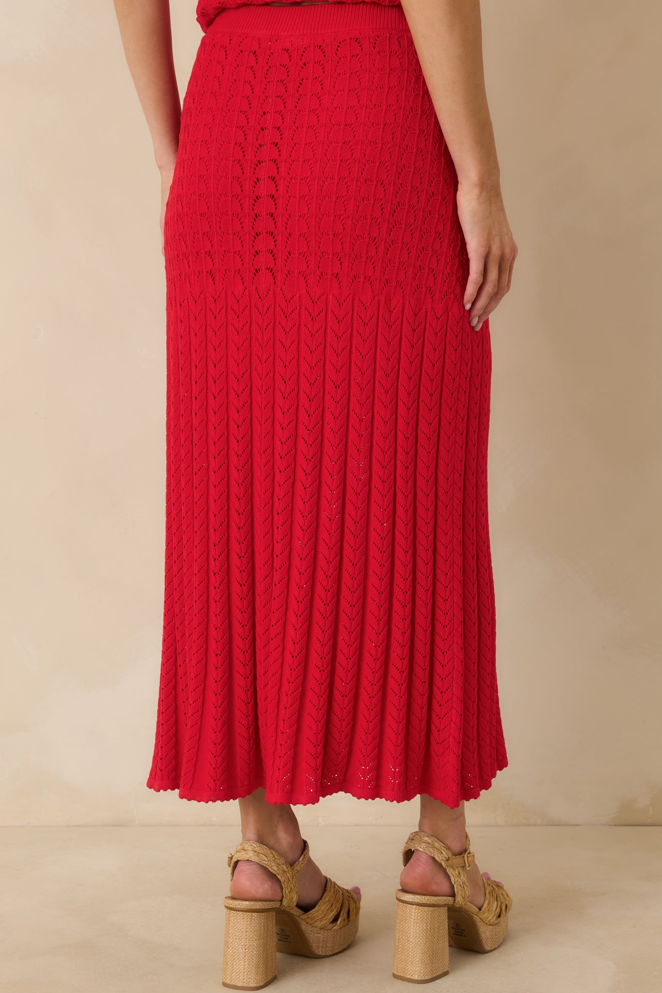 Rear view of the red sweater skirt highlighting the elastic waistband and streamlined midi silhouette.