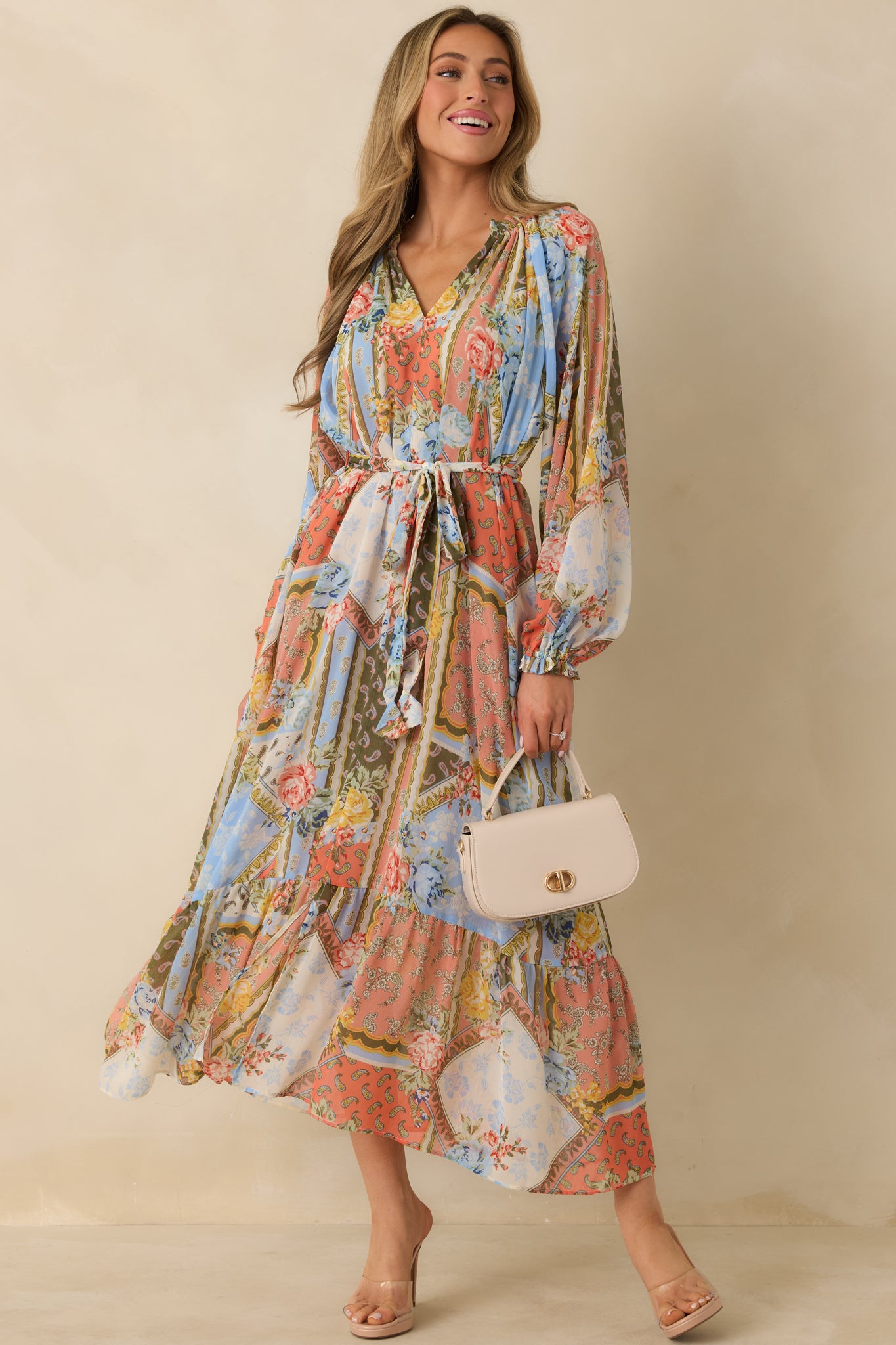 Floral print dress with ruffled collar, elastic cuffs, and layered skirt with soft movement.