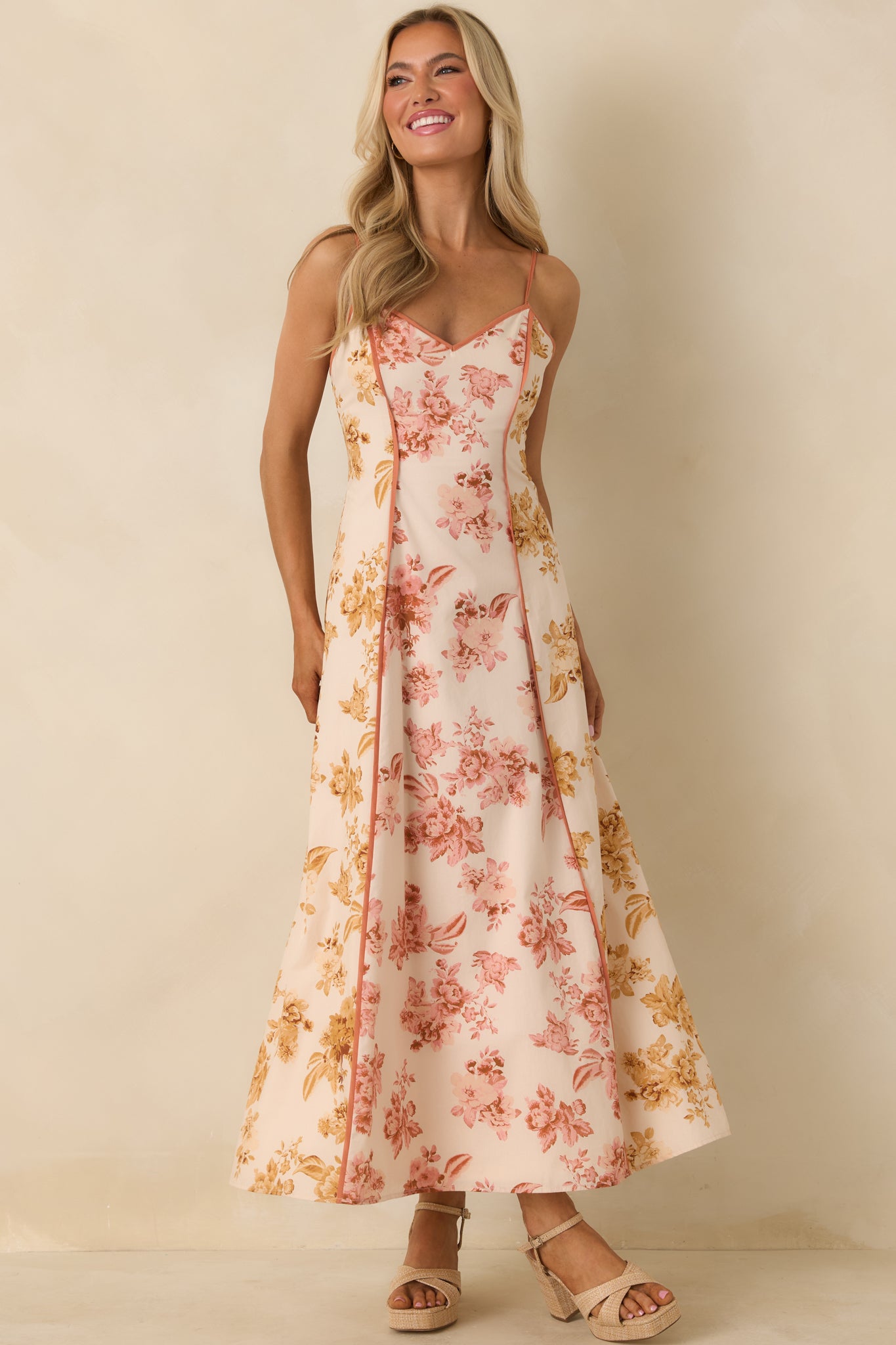 Rose pink and yellow maxi dress with clay trim accents and airy, floor-length skirt.