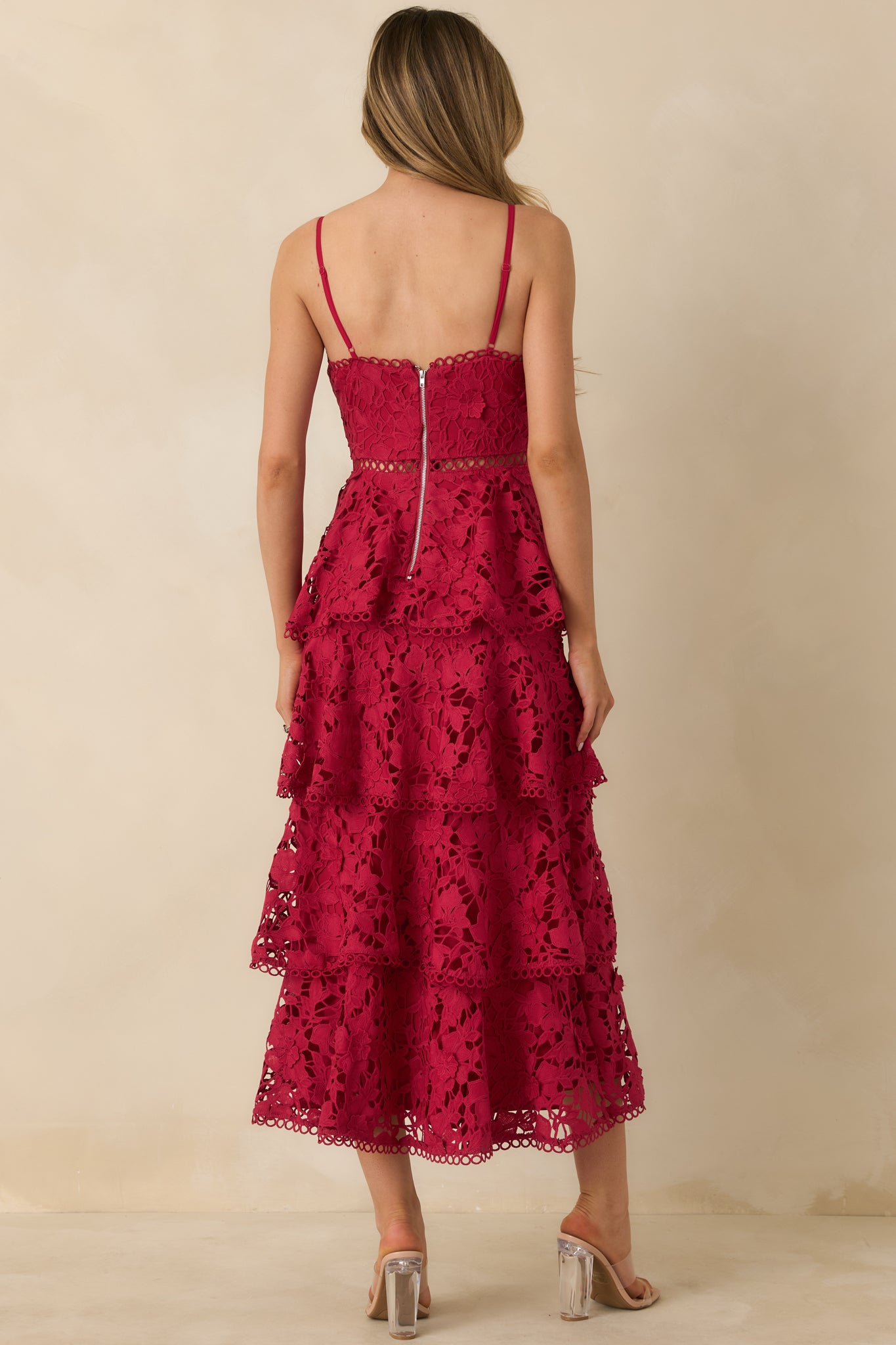 Rear view of red maxi dress highlighting functional back zipper, tiered lace overlay, and adjustable straps.