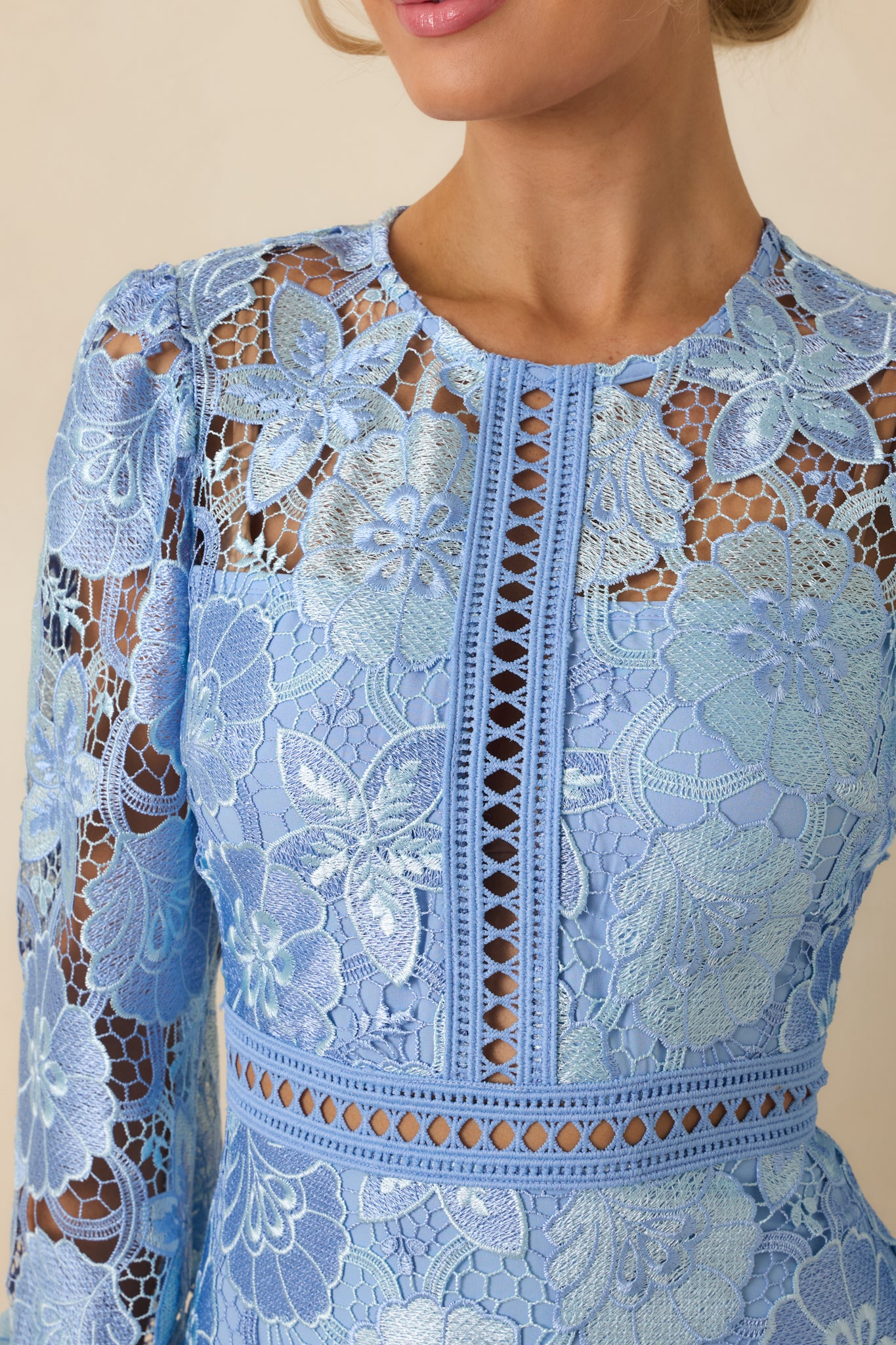 Close-up of mini dress showing transparent detailing, elastic cuffed sleeves, and single-tier fabric texture.