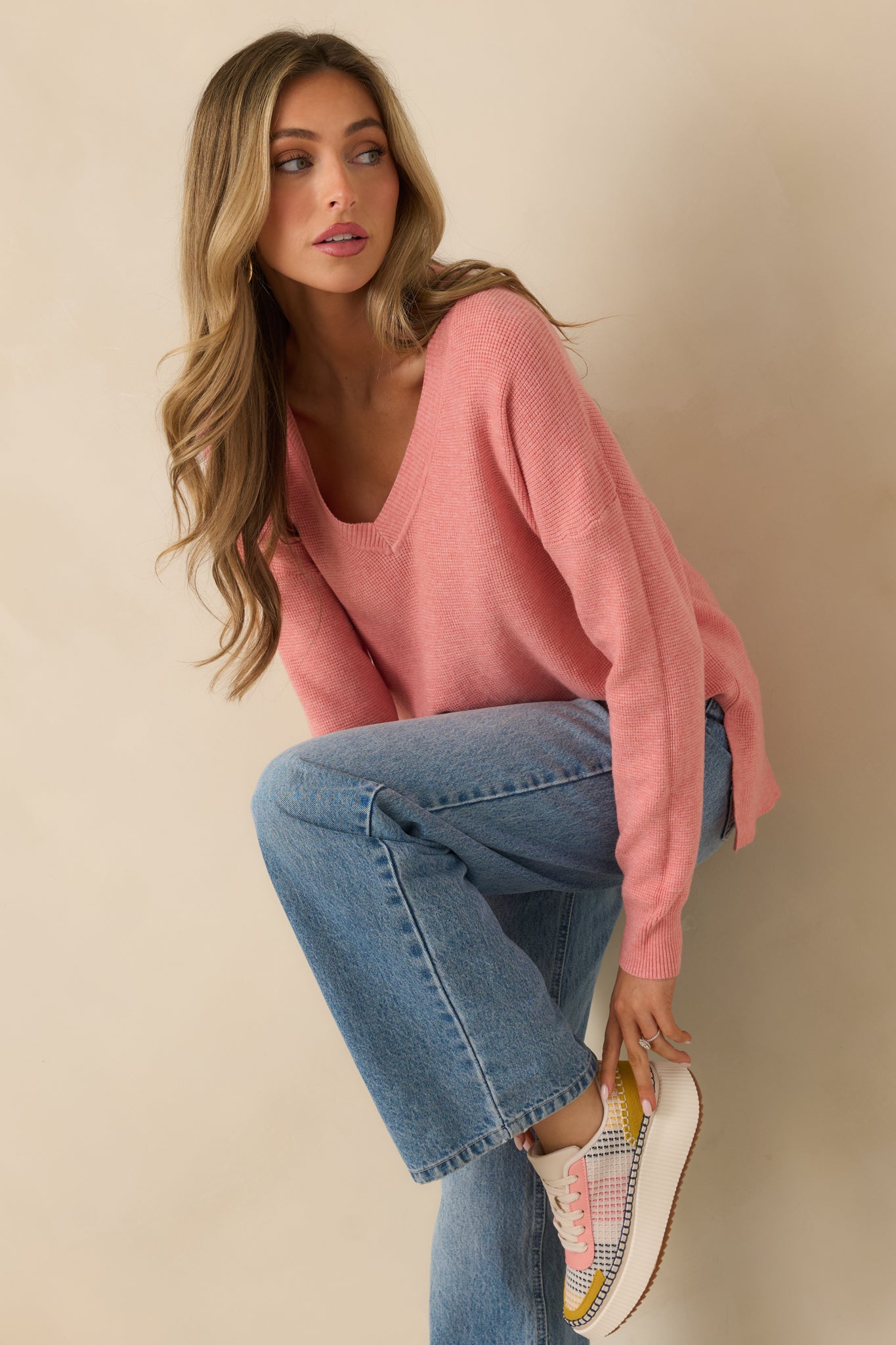 Cropped front view highlighting split hem detail and lightweight knit feel.