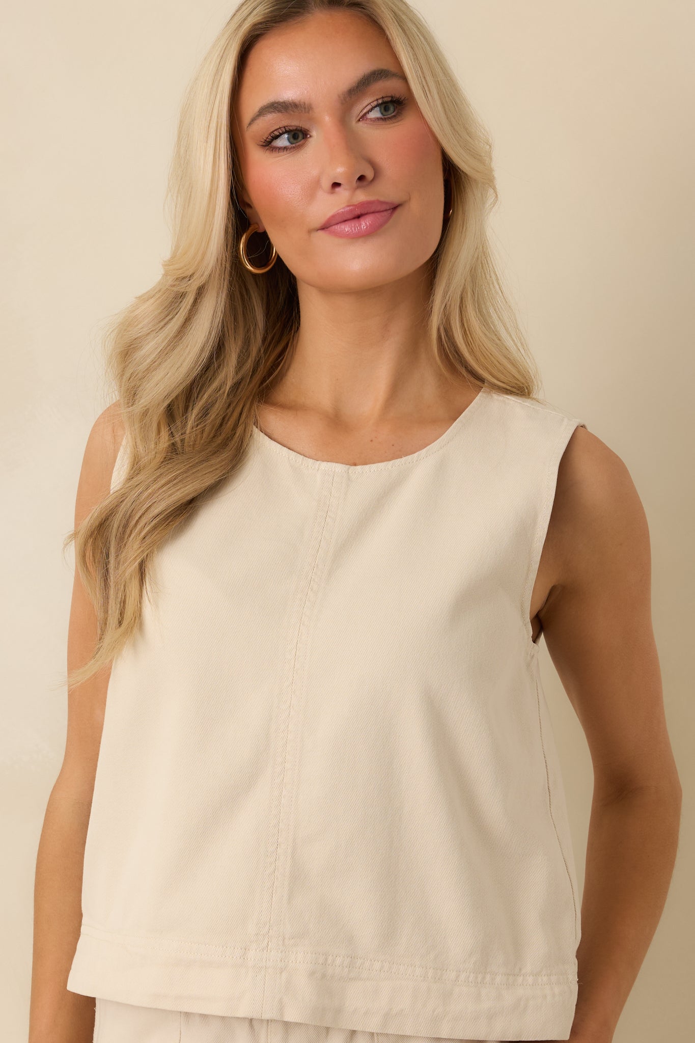 Closer view of the front neckline and structured silhouette of the sleeveless tank.