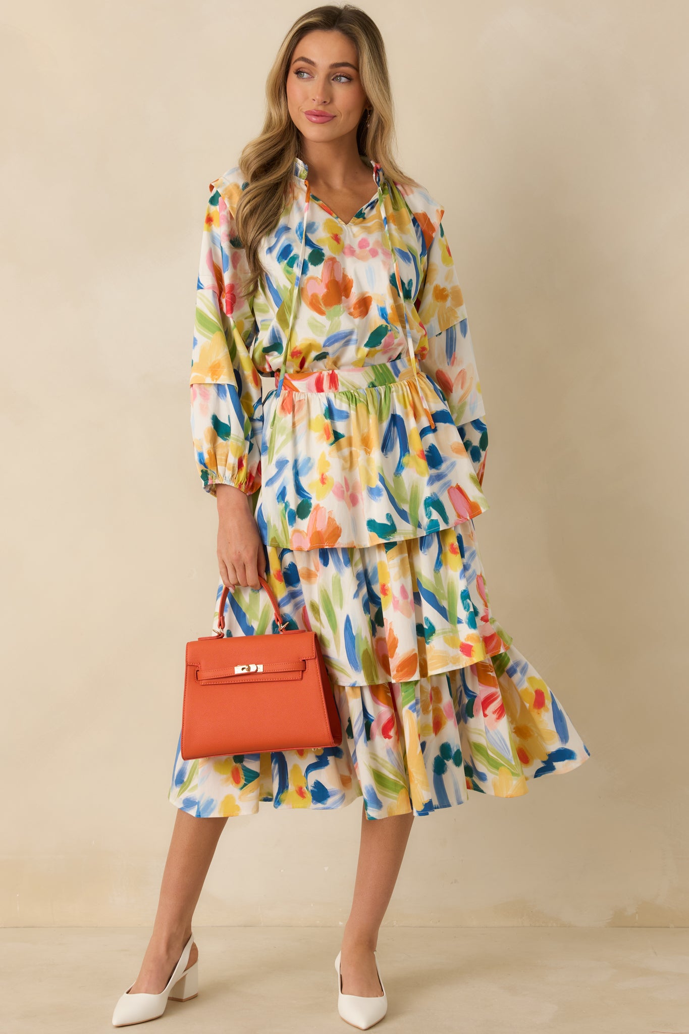 Multicolored abstract floral print top with a relaxed silhouette, split neckline, and softly gathered body in lightweight woven cotton.