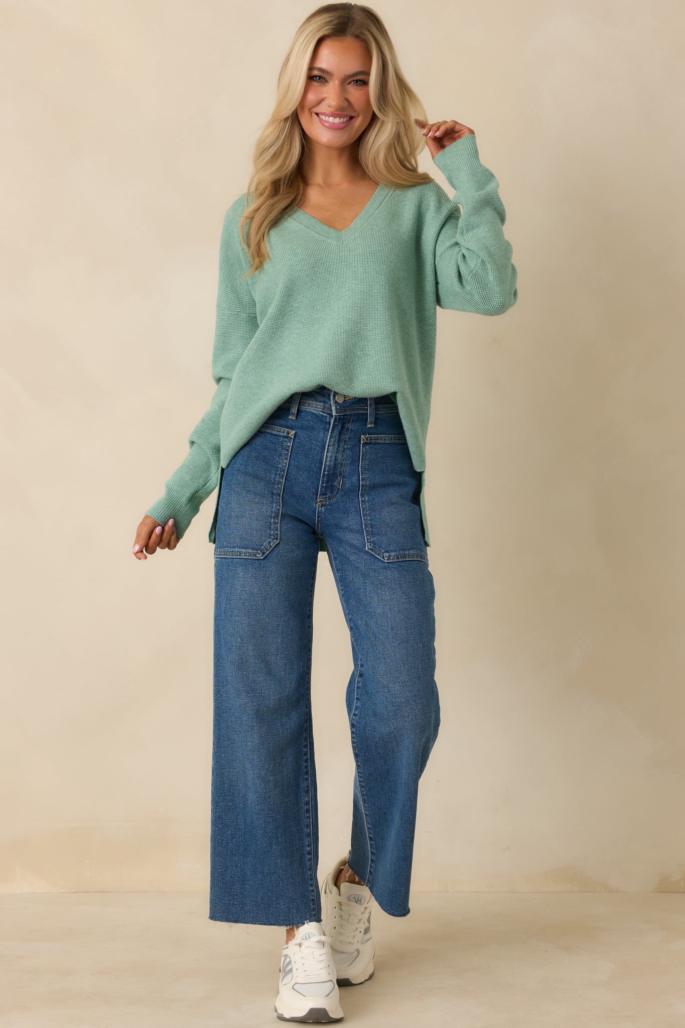 Lightweight green sweater with a V-neck, ribbed sleeve cuffs, and comfortable everyday fit.