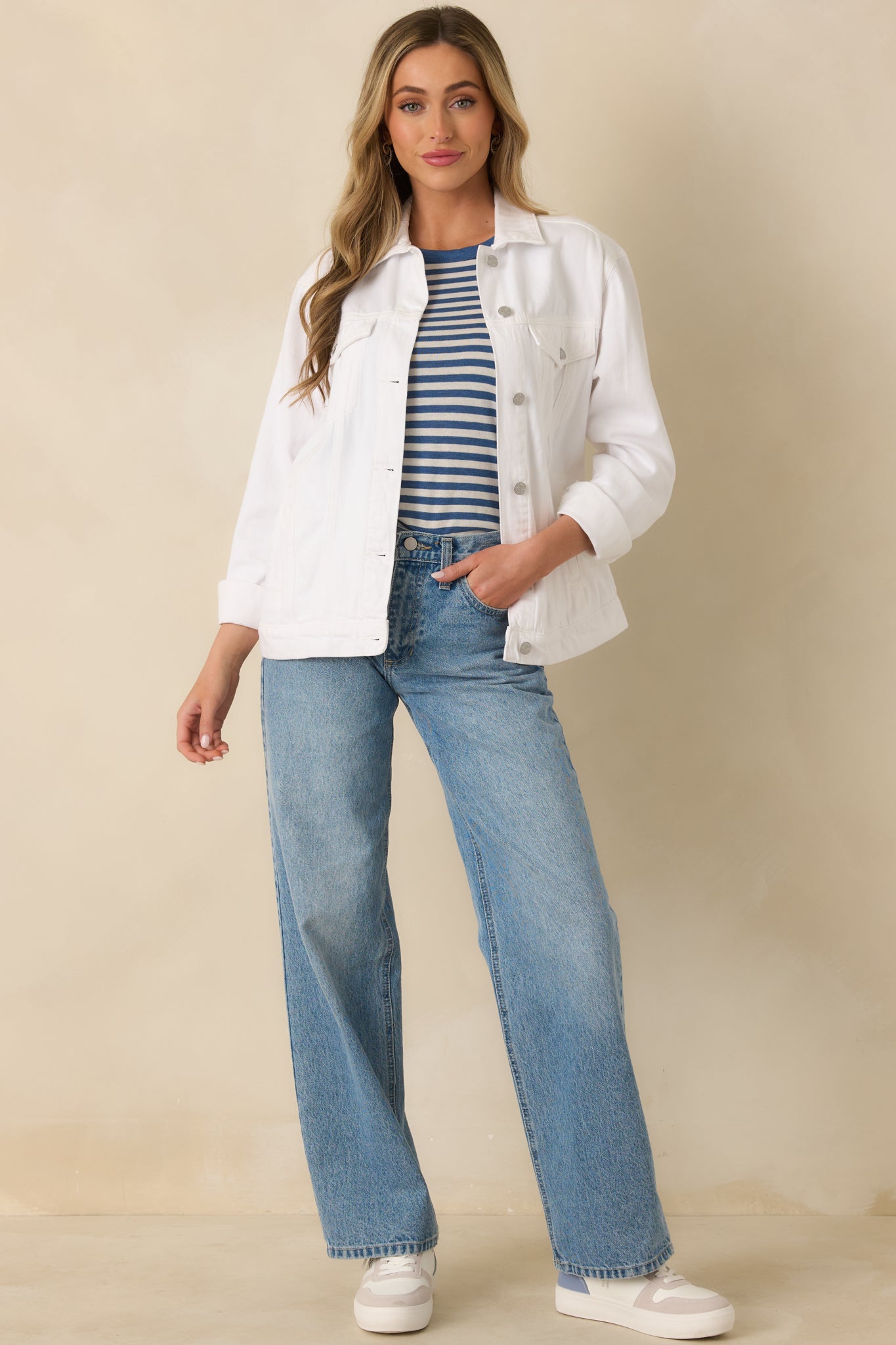 Front view of a white denim jacket with a white collar, button-front closure, and functional chest pockets.
