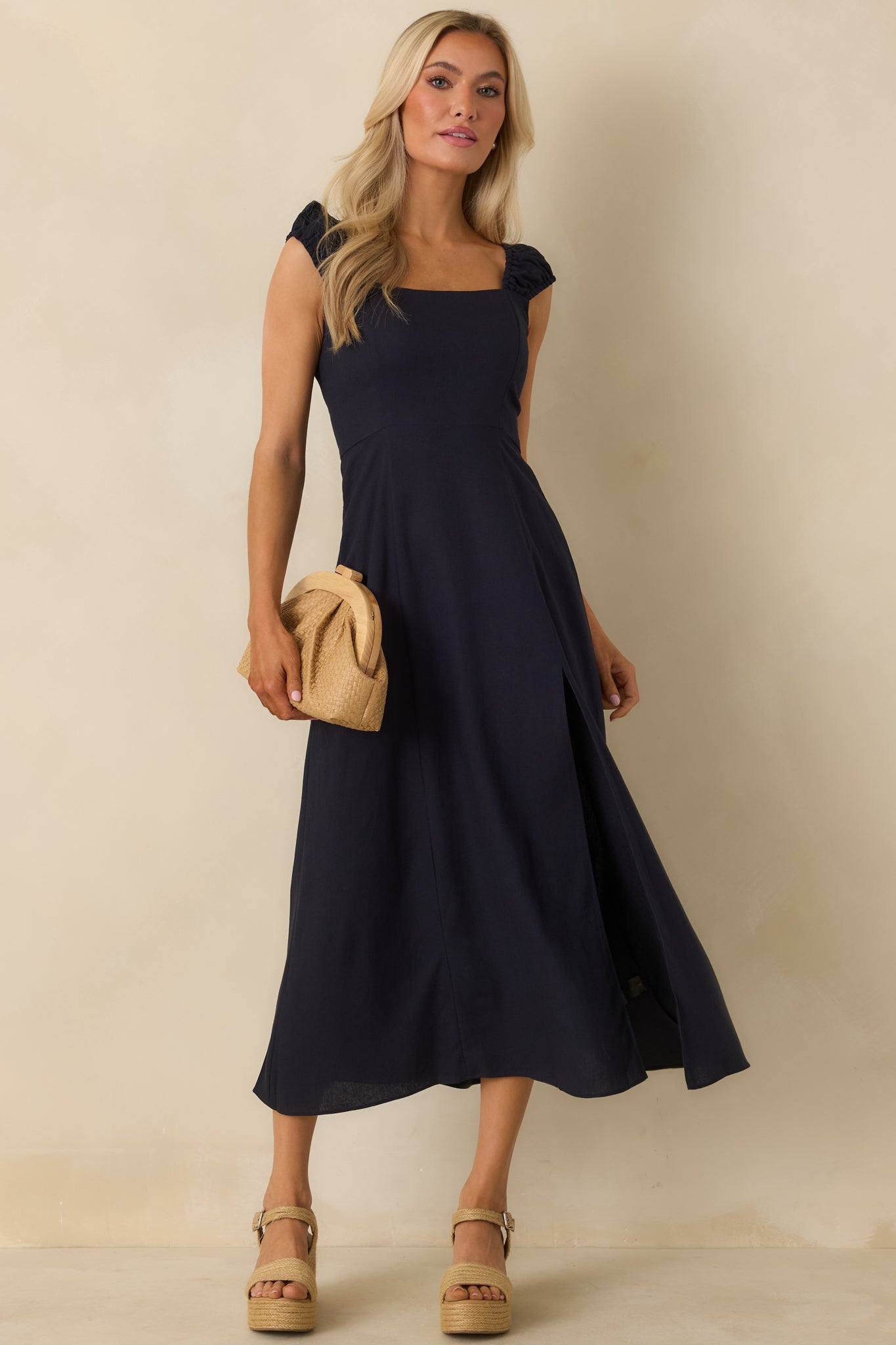 Angled front view highlighting the smocked sleeves and fluid movement of the skirt.