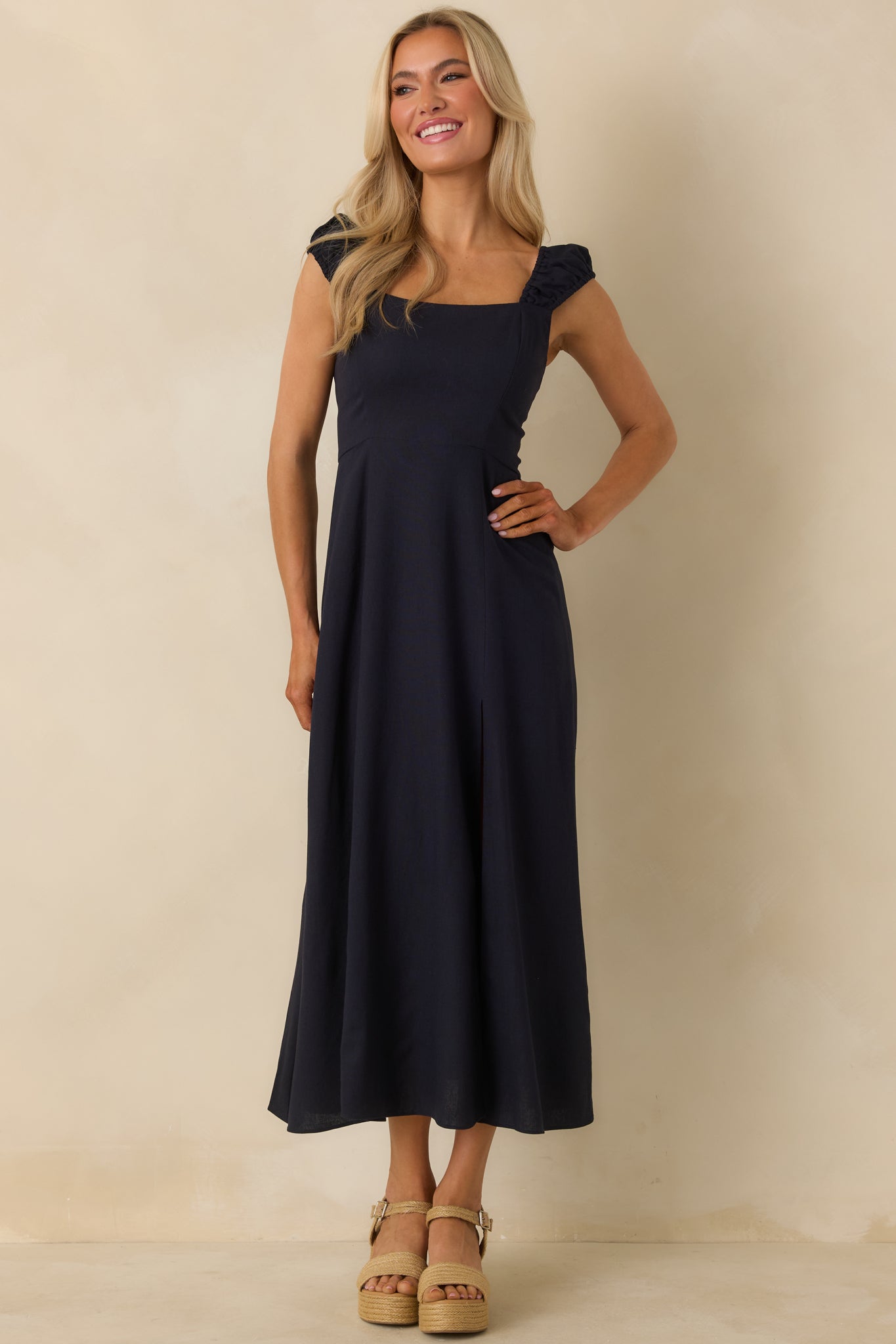 Front-facing angle focusing on the leg slit and drape of the flowing skirt.