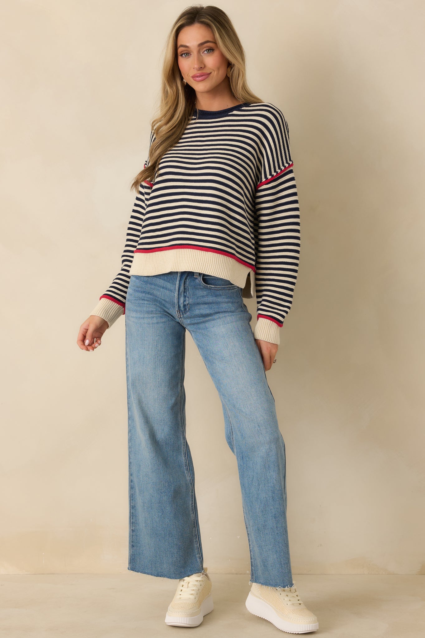 Navy crewneck sweater with an allover horizontal stripe pattern, long sleeves, and ribbed cuffs and hem for a structured fit.