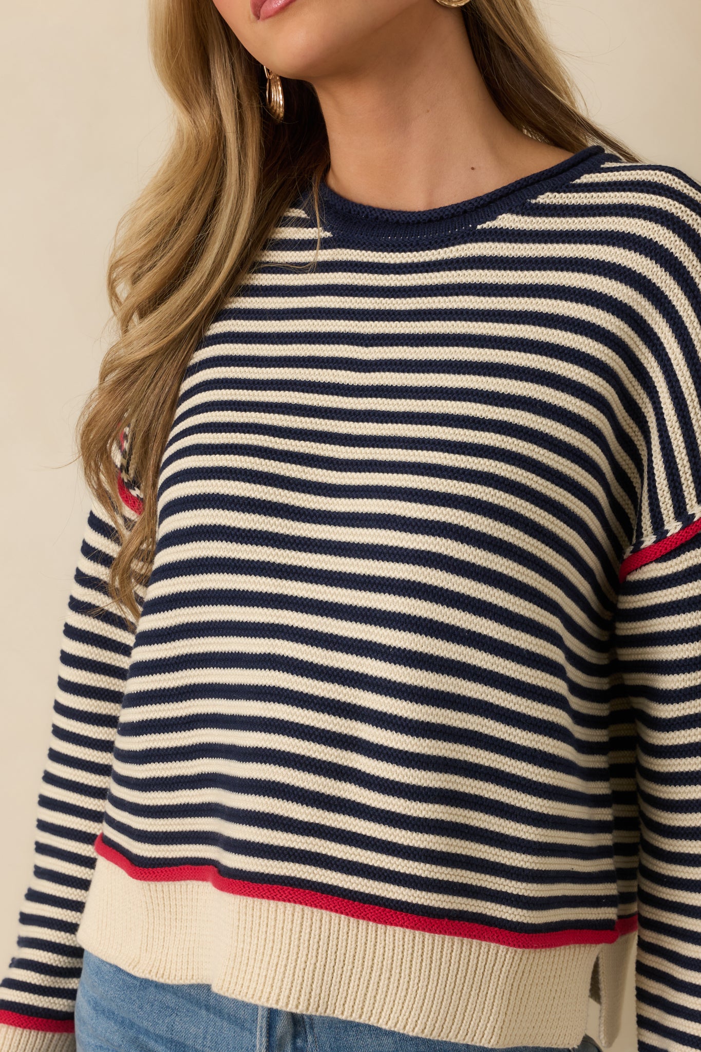 Detailed view of the navy stripe crewneck sweater showing horizontal stripe pattern, ribbed trim at neckline, cuffs, and hem, and soft cotton-blend knit texture.