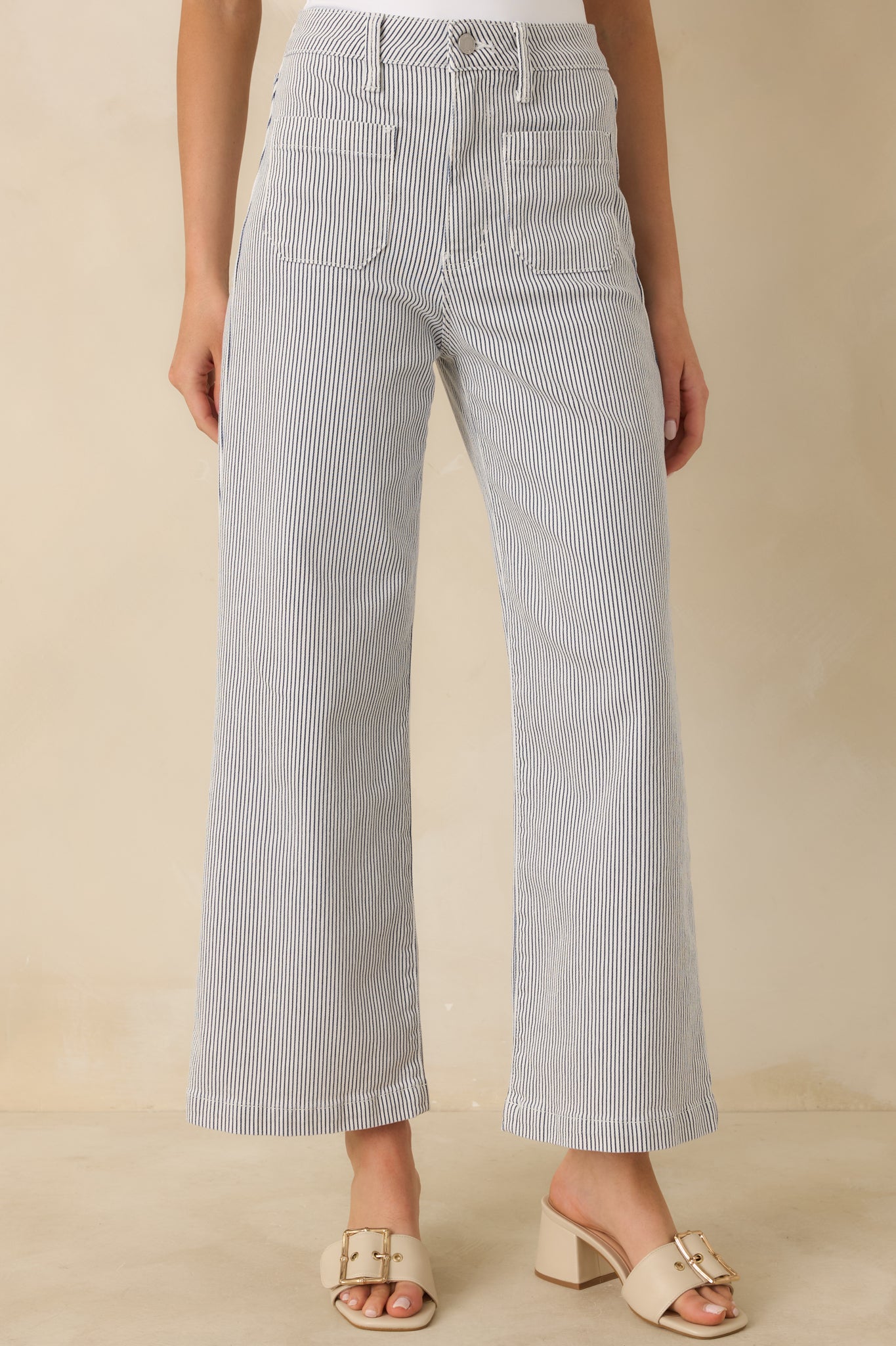 Detail crop highlighting the functional front pockets and smooth denim texture.