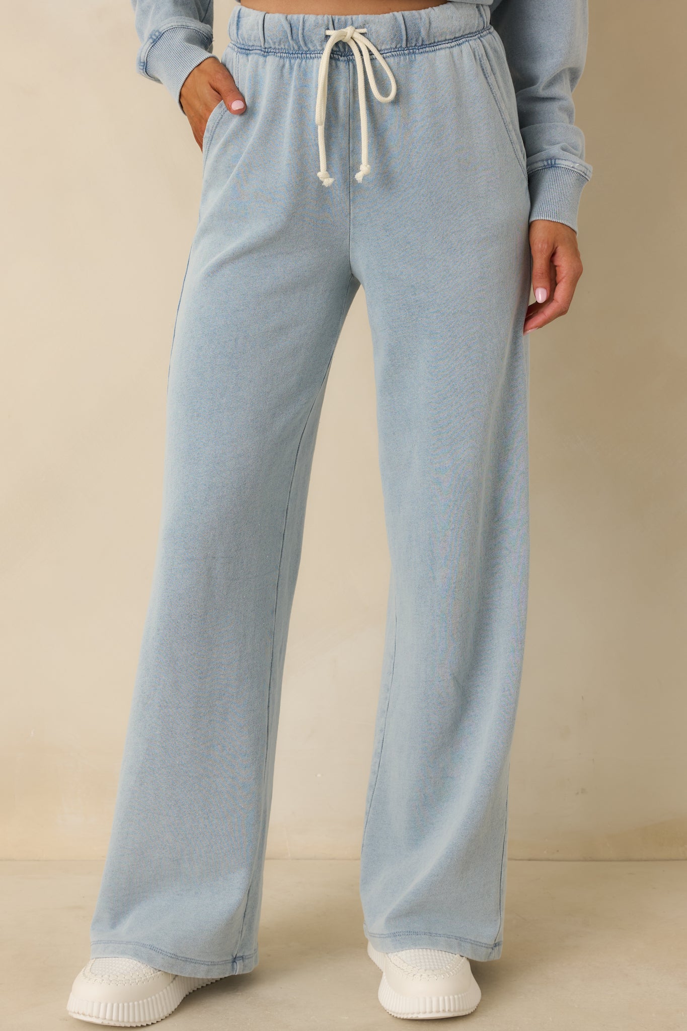 Cropped detail of the pants emphasizing the side pockets and soft knit fabric texture.