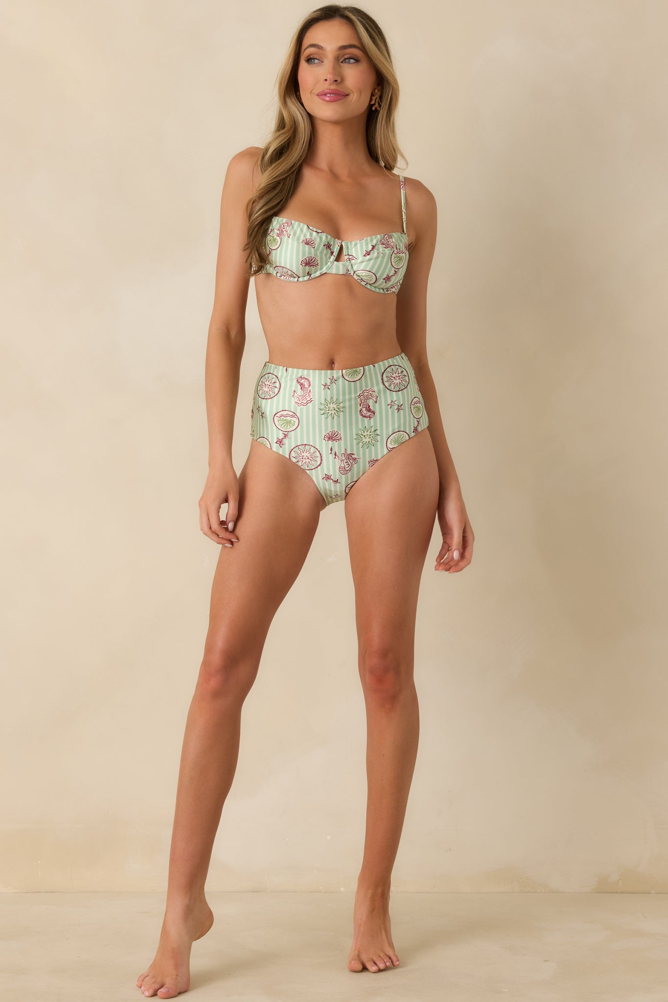 Green striped bikini bottoms highlighting a flattering high-rise silhouette and lightweight fabric.