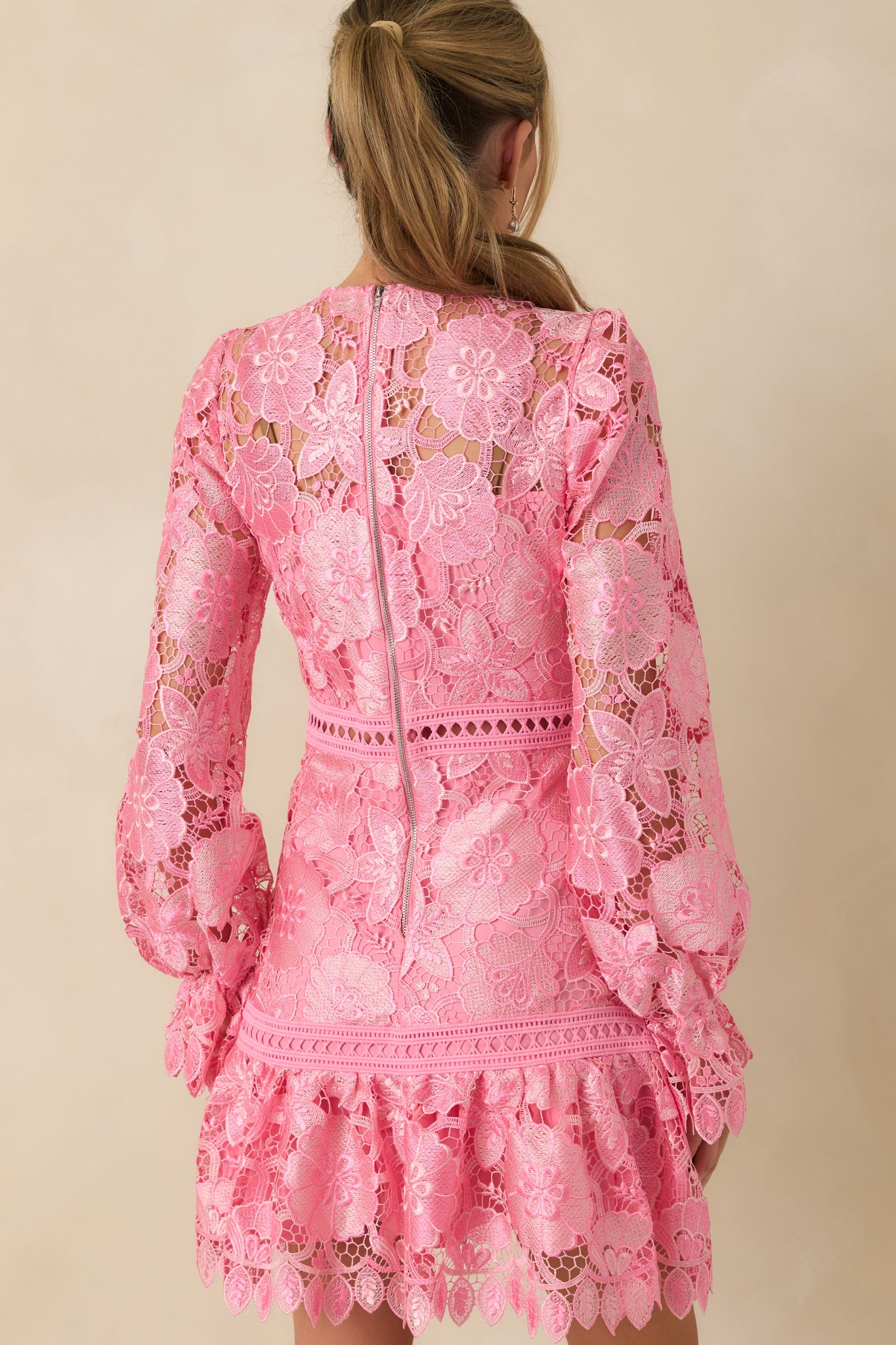 Back view of pink mini dress highlighting the zipper closure and elastic cuff sleeves.