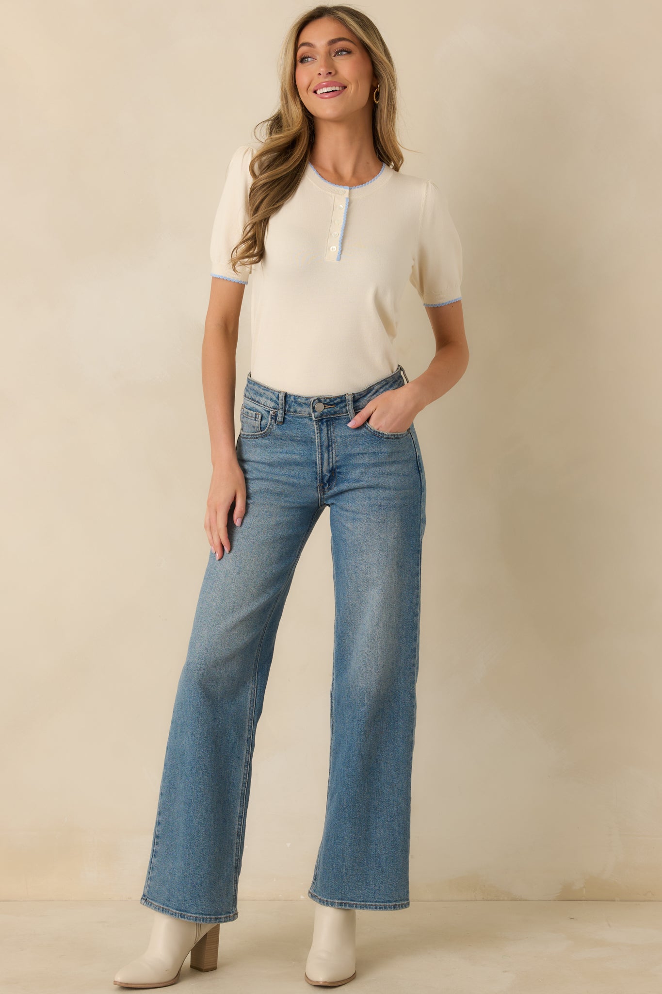 Straight-on front angle showing the blue trim along the neckline and hem, and the relaxed fit of the sweater.