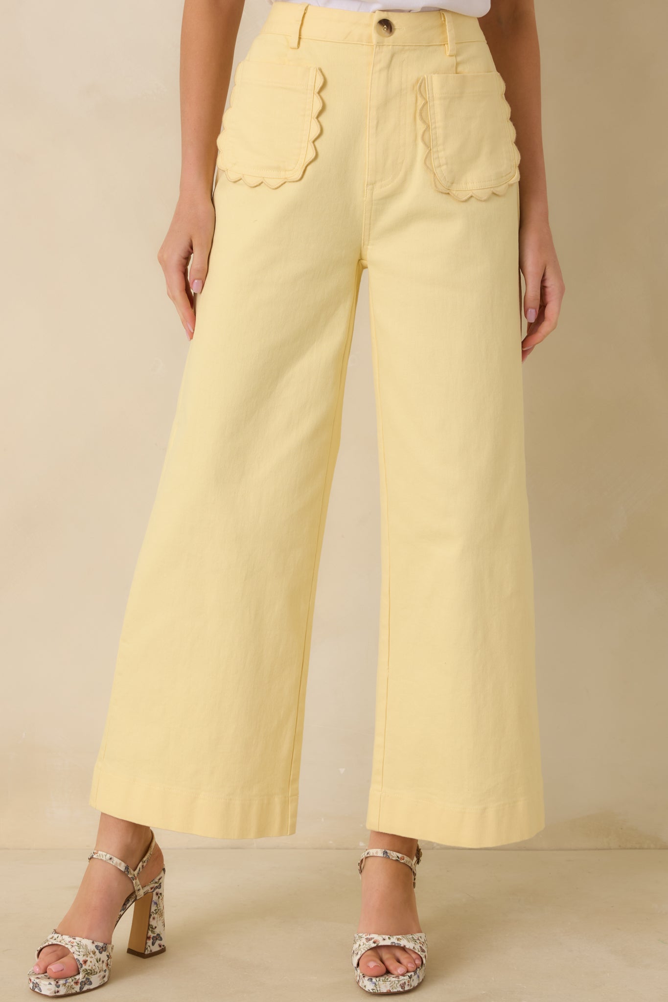 Front view of yellow pants showing scalloped patch pockets and neat belt loops.