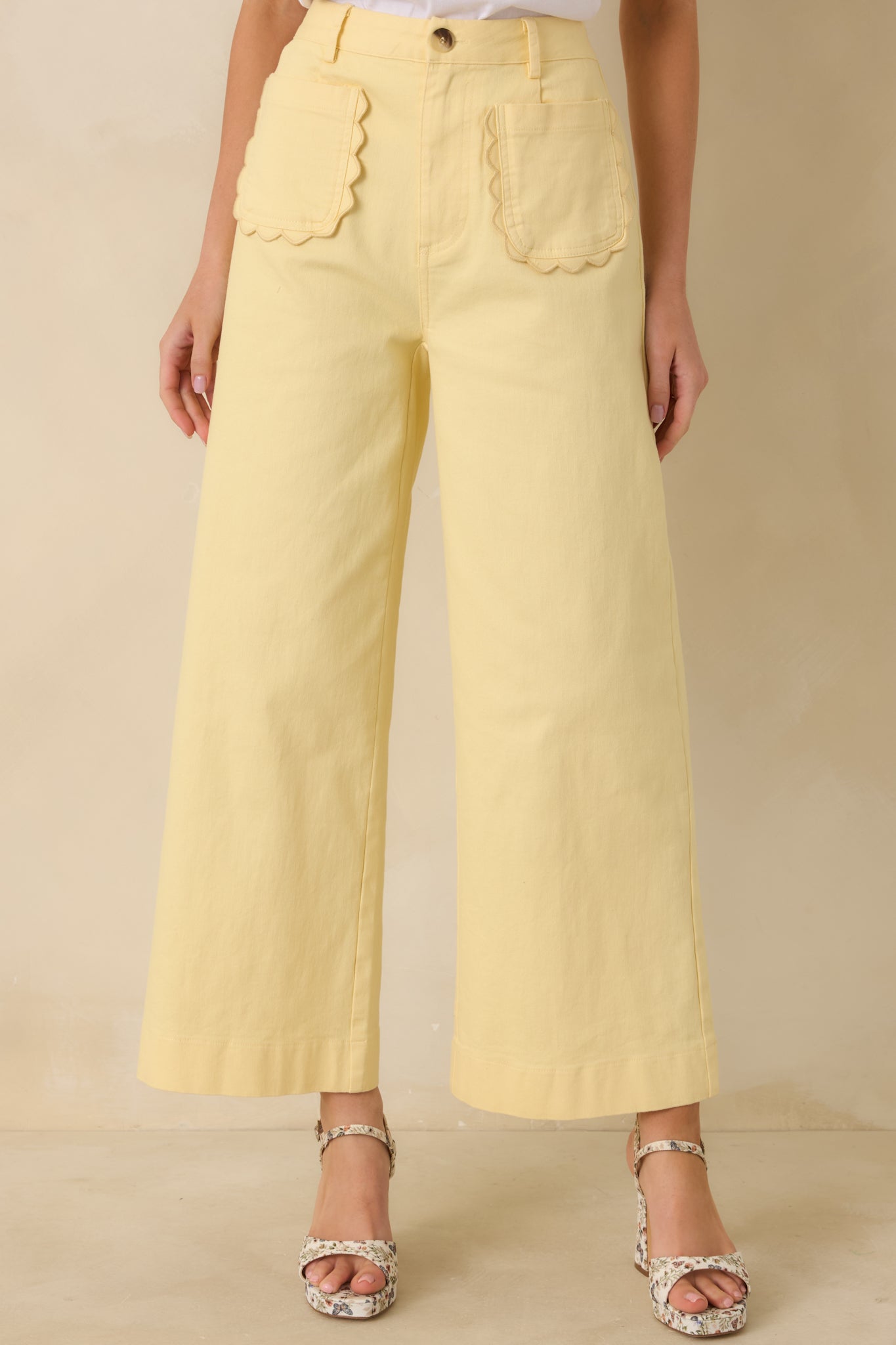 Yellow pants fabric texture and wide leg silhouette highlighted from front angle.